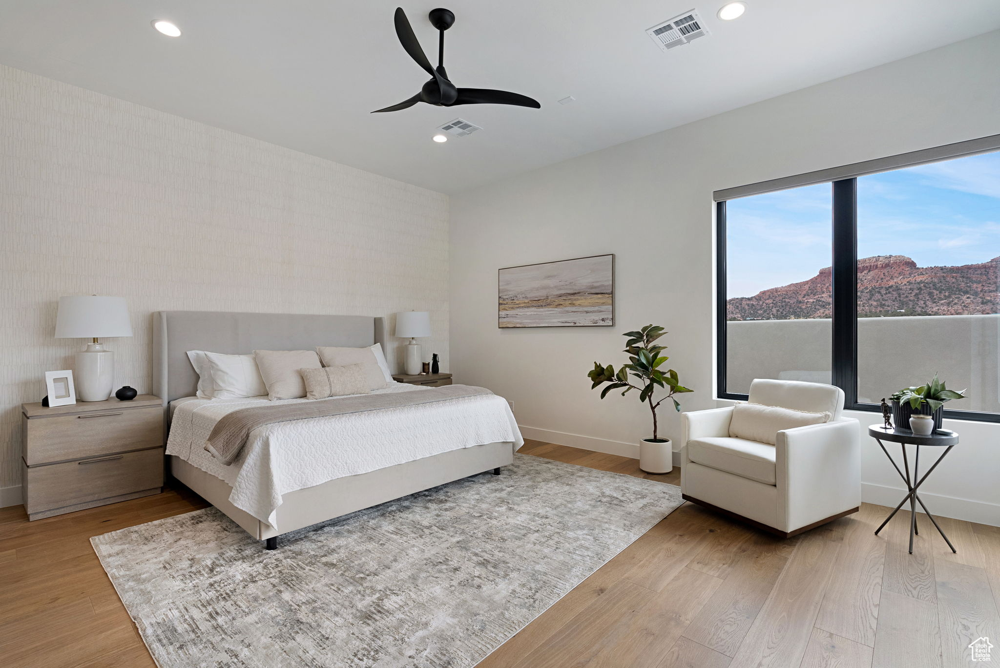 Bedroom featuring ceiling fan, a mountain view, and light hardwood / wood-style floors