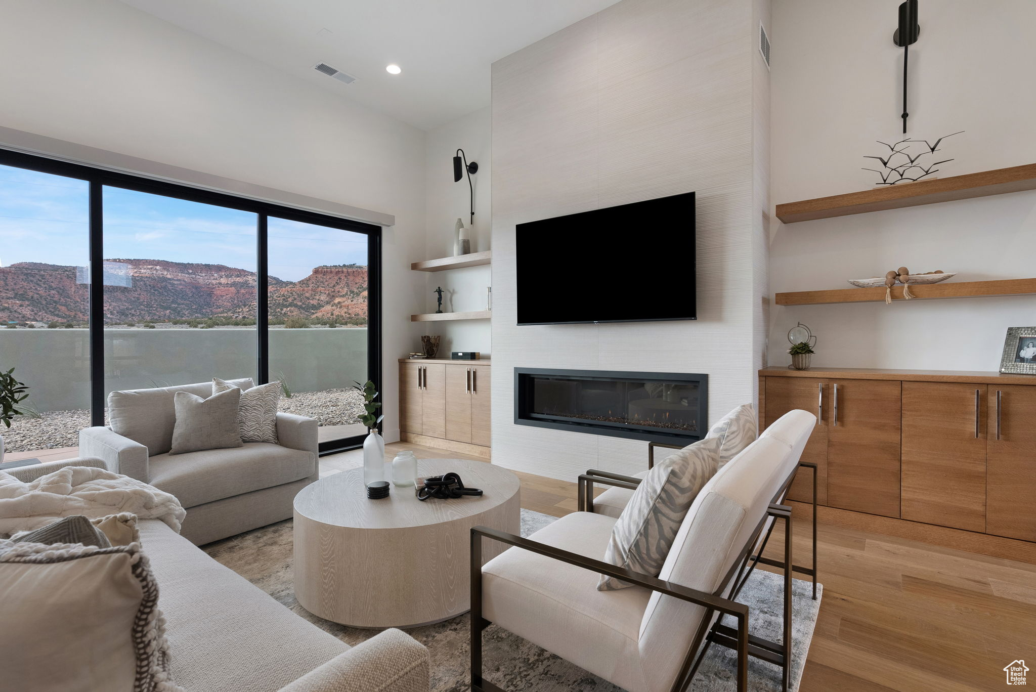 Living room featuring a large fireplace, a mountain view, and light hardwood / wood-style floors