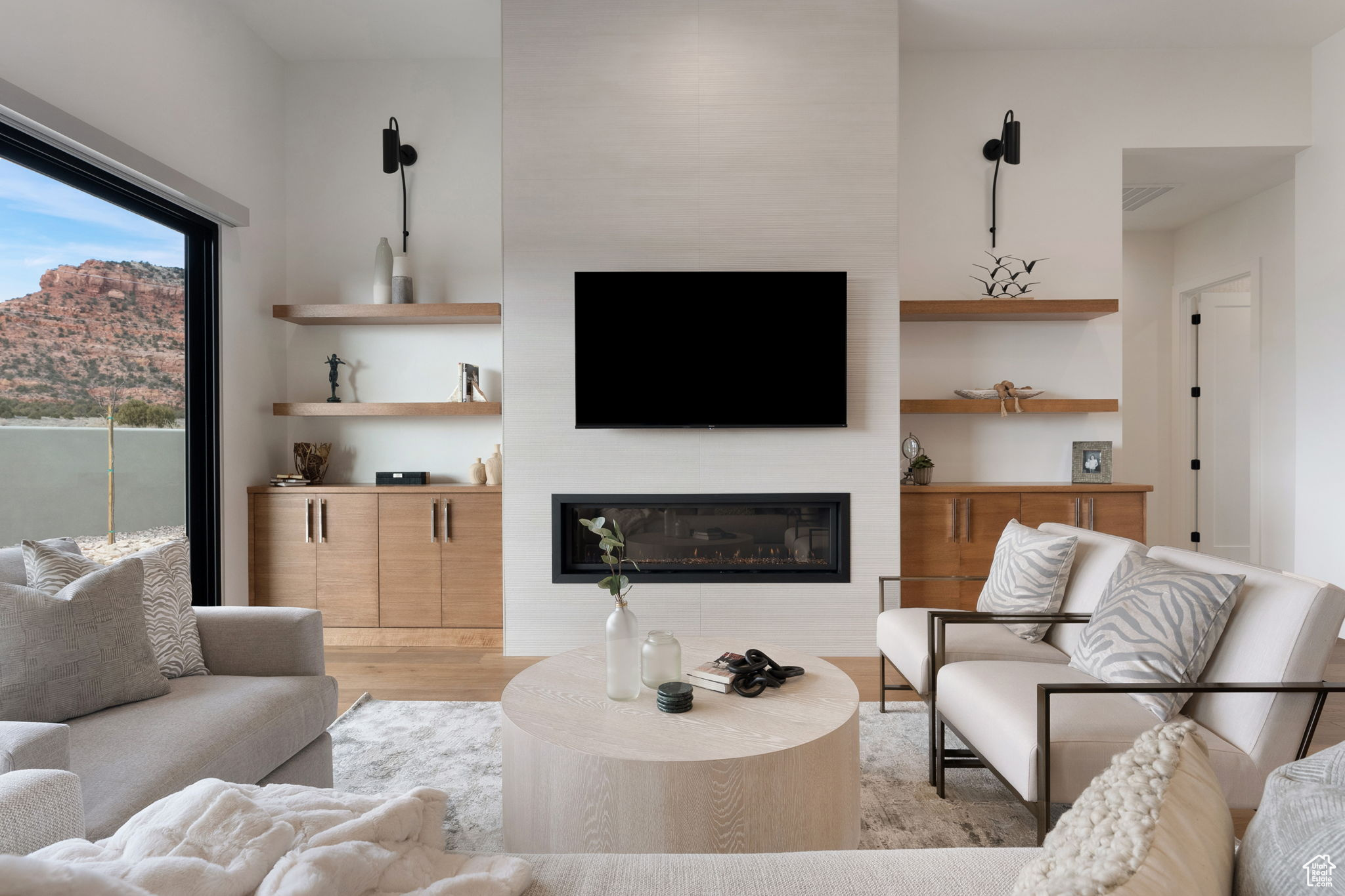 Living room with a fireplace and light hardwood / wood-style floors