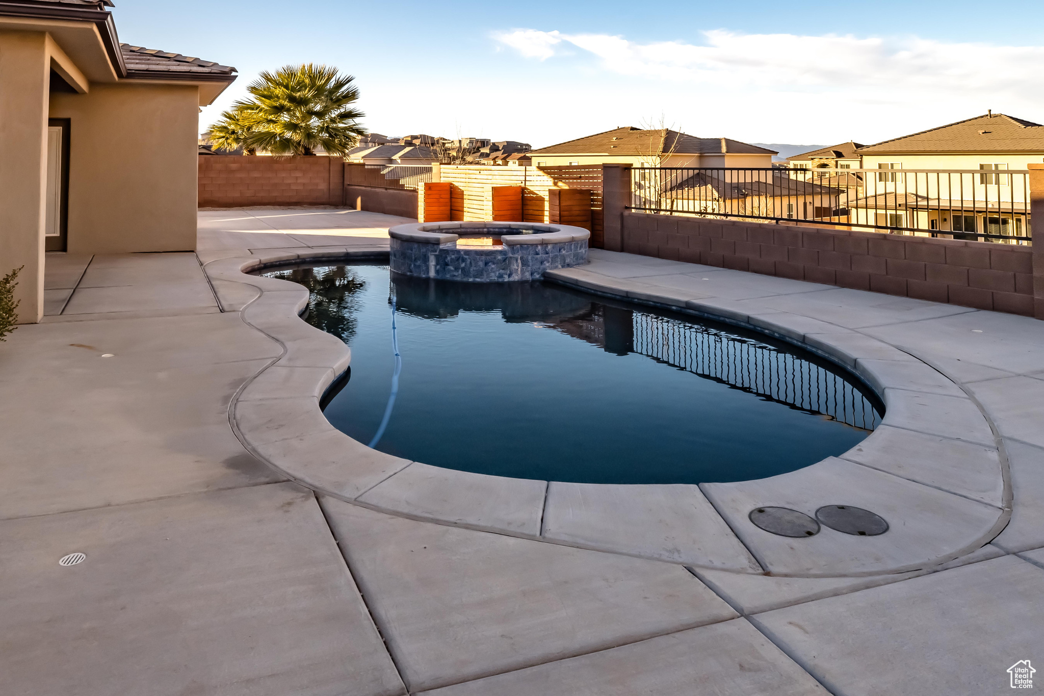 View of swimming pool featuring an in ground hot tub