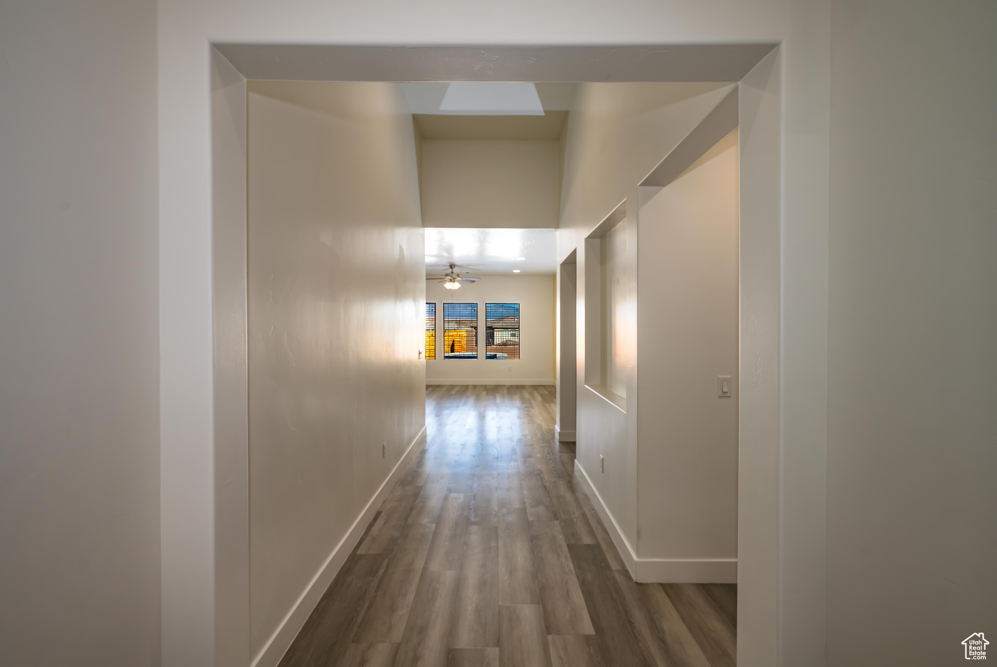 Hall with hardwood / wood-style flooring