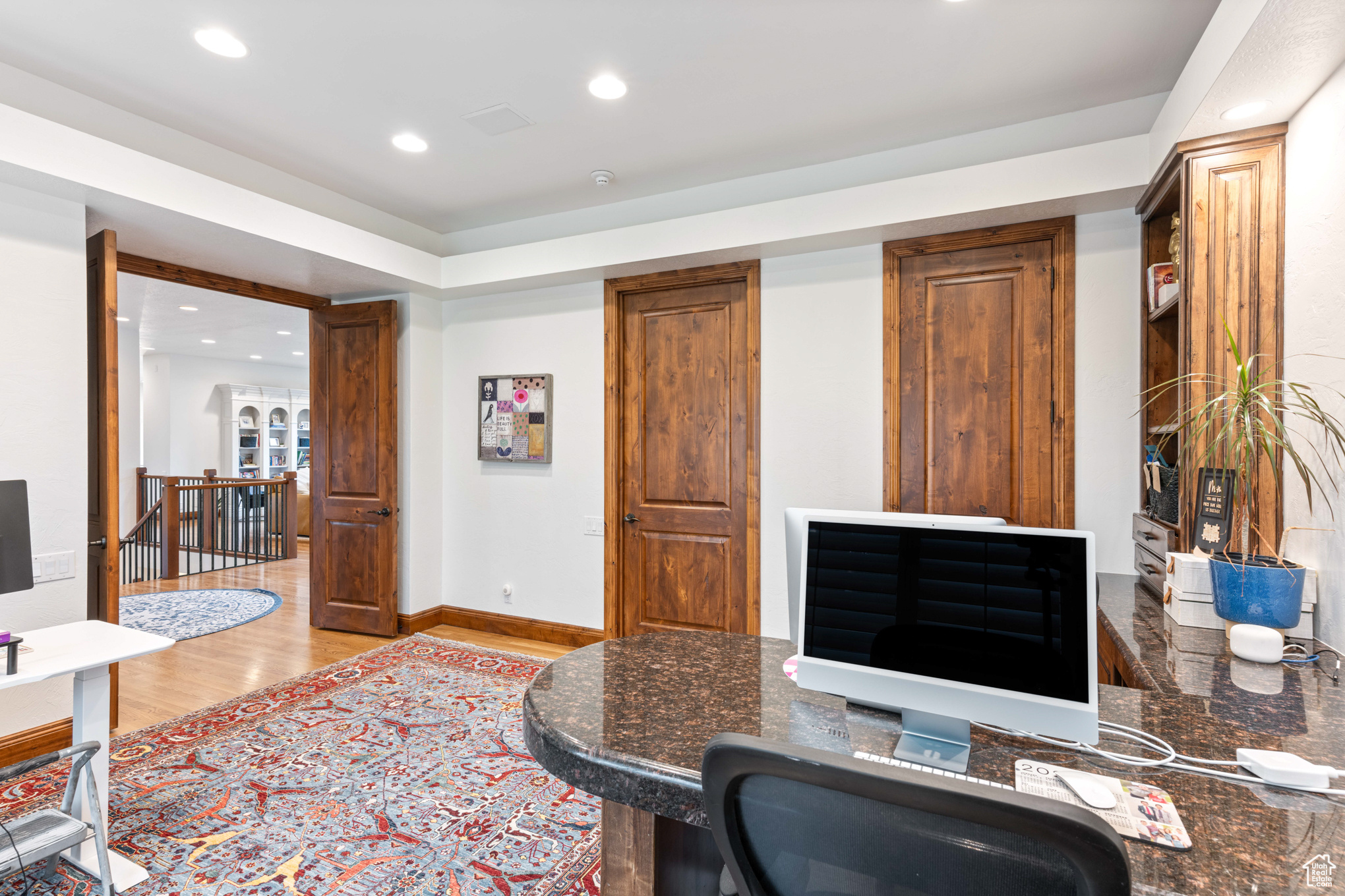 Office area with light hardwood / wood-style floors