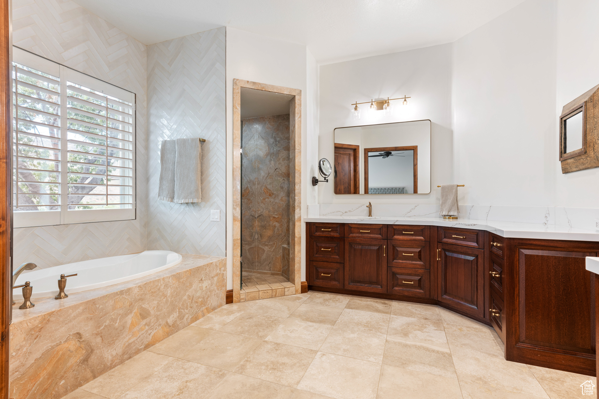 Bathroom with vanity and separate shower and tub