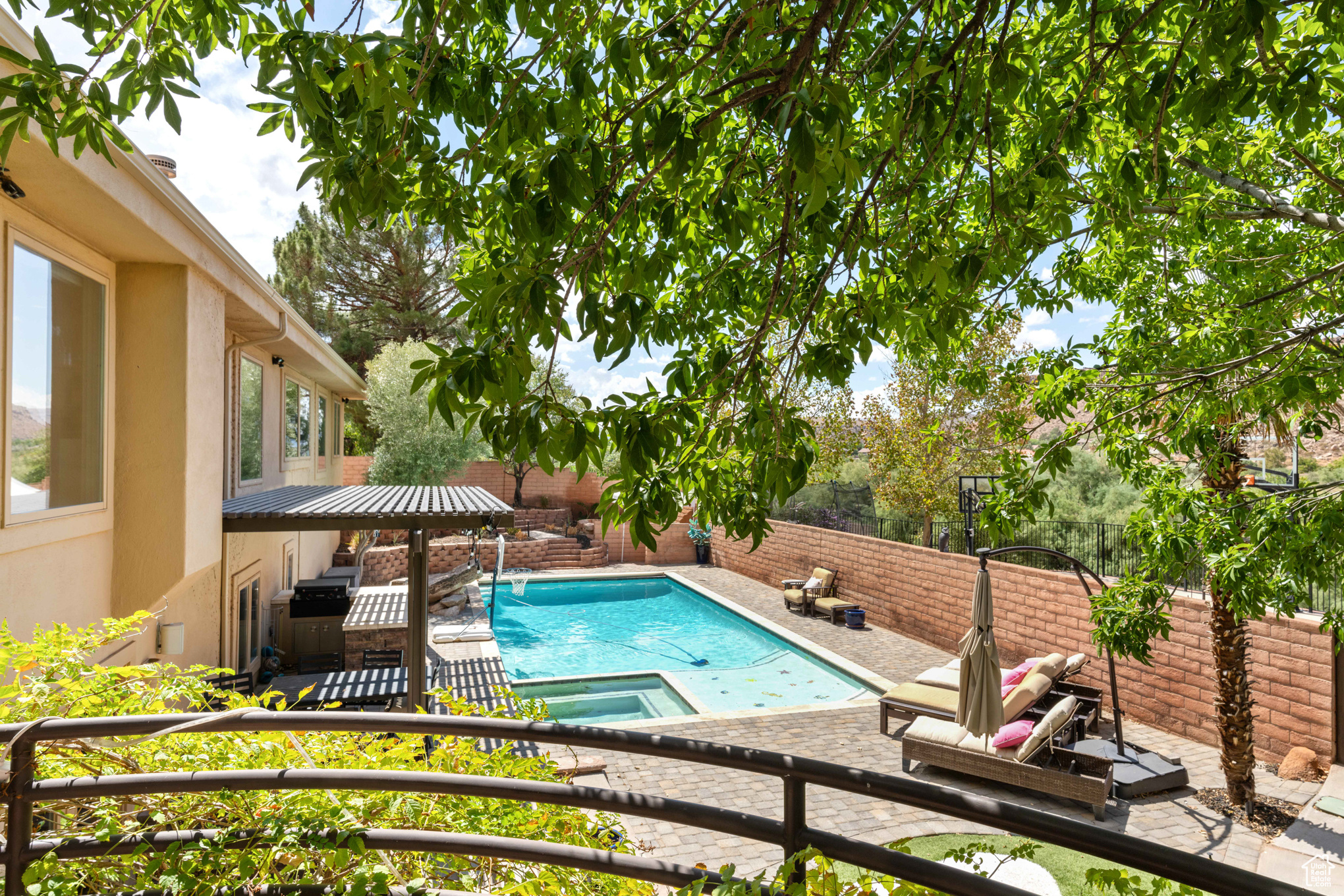 View of pool with an in ground hot tub and a patio area