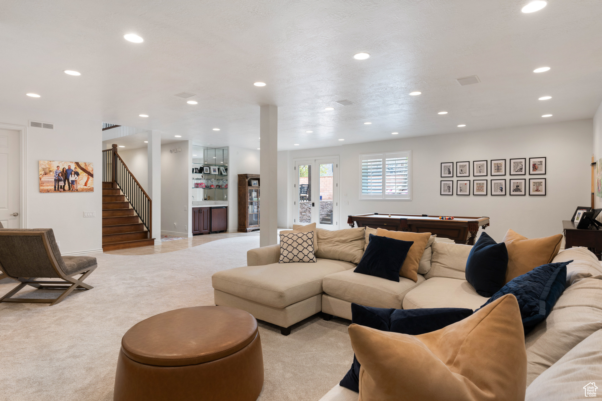 Carpeted living room with pool table