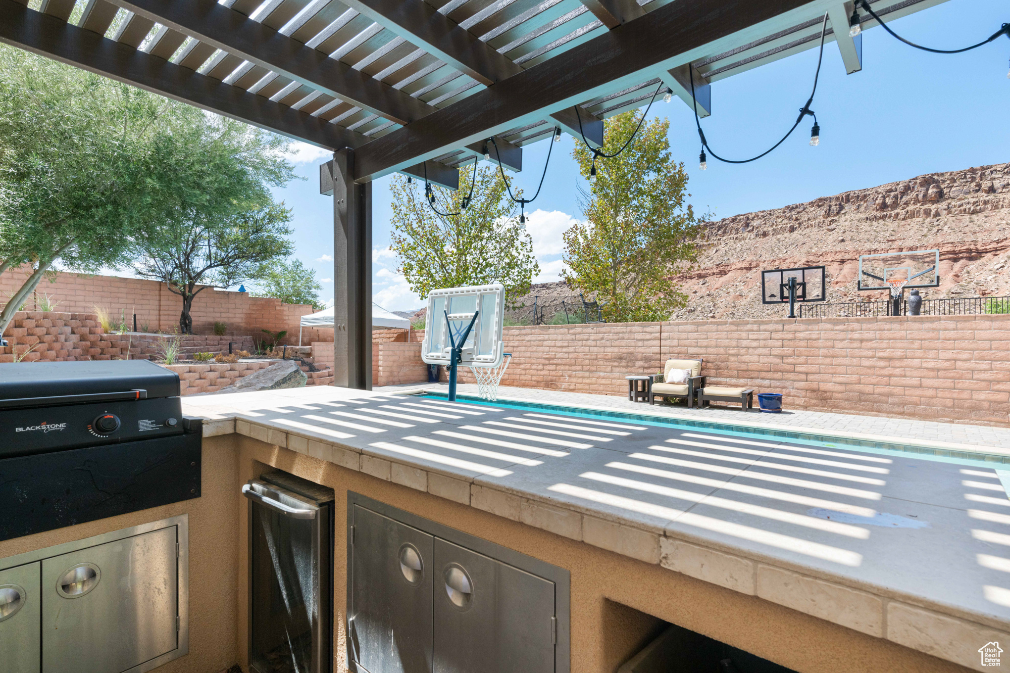 View of patio with a pergola and area for grilling