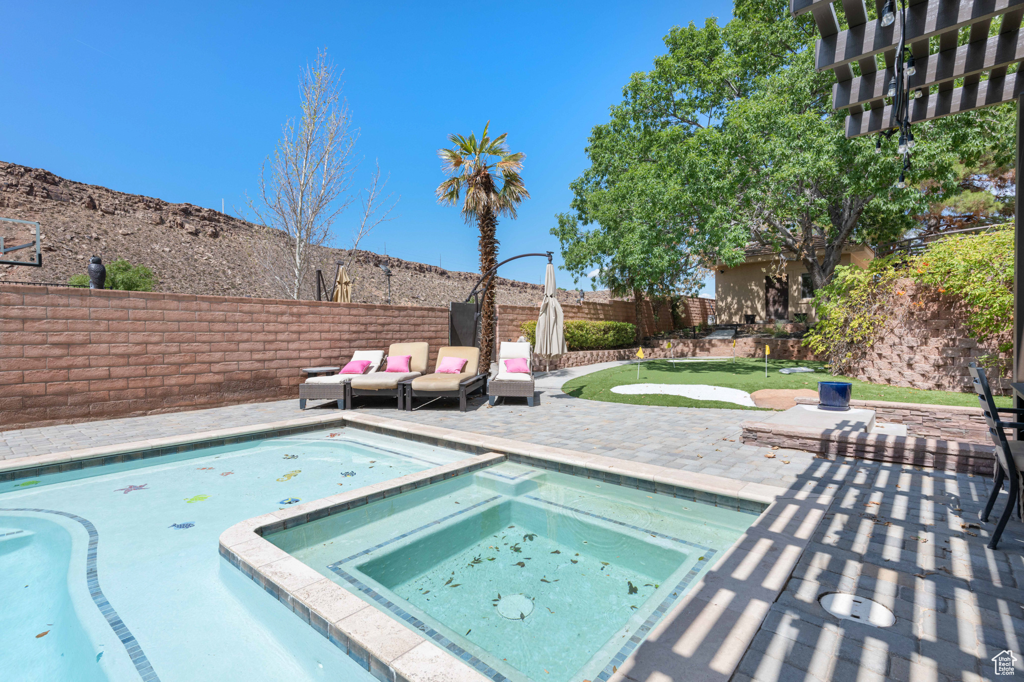 View of pool with a patio area and an in ground hot tub