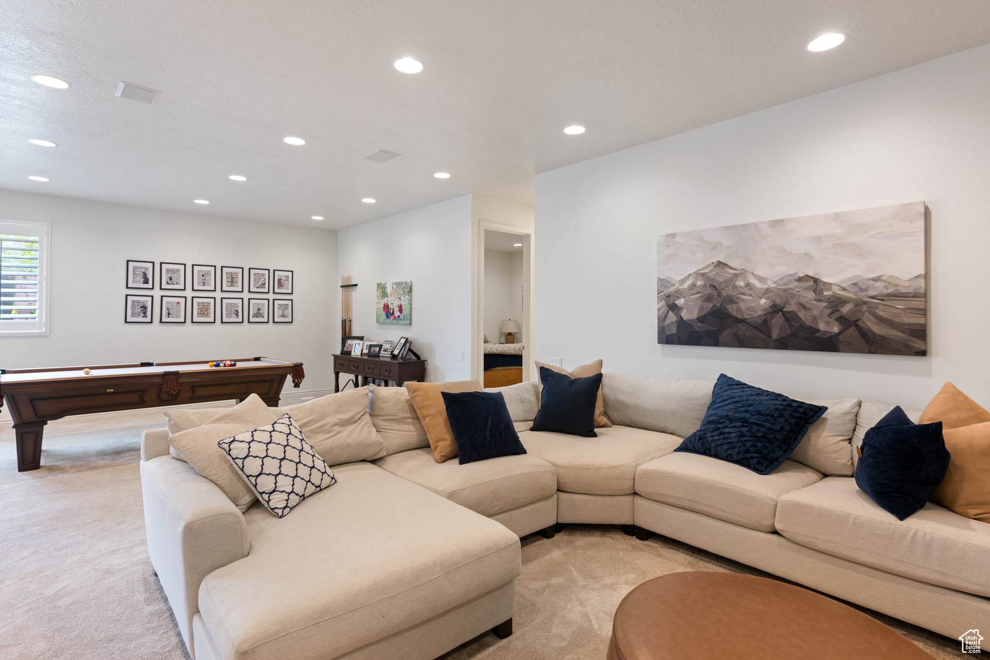 Living room featuring light colored carpet and billiards