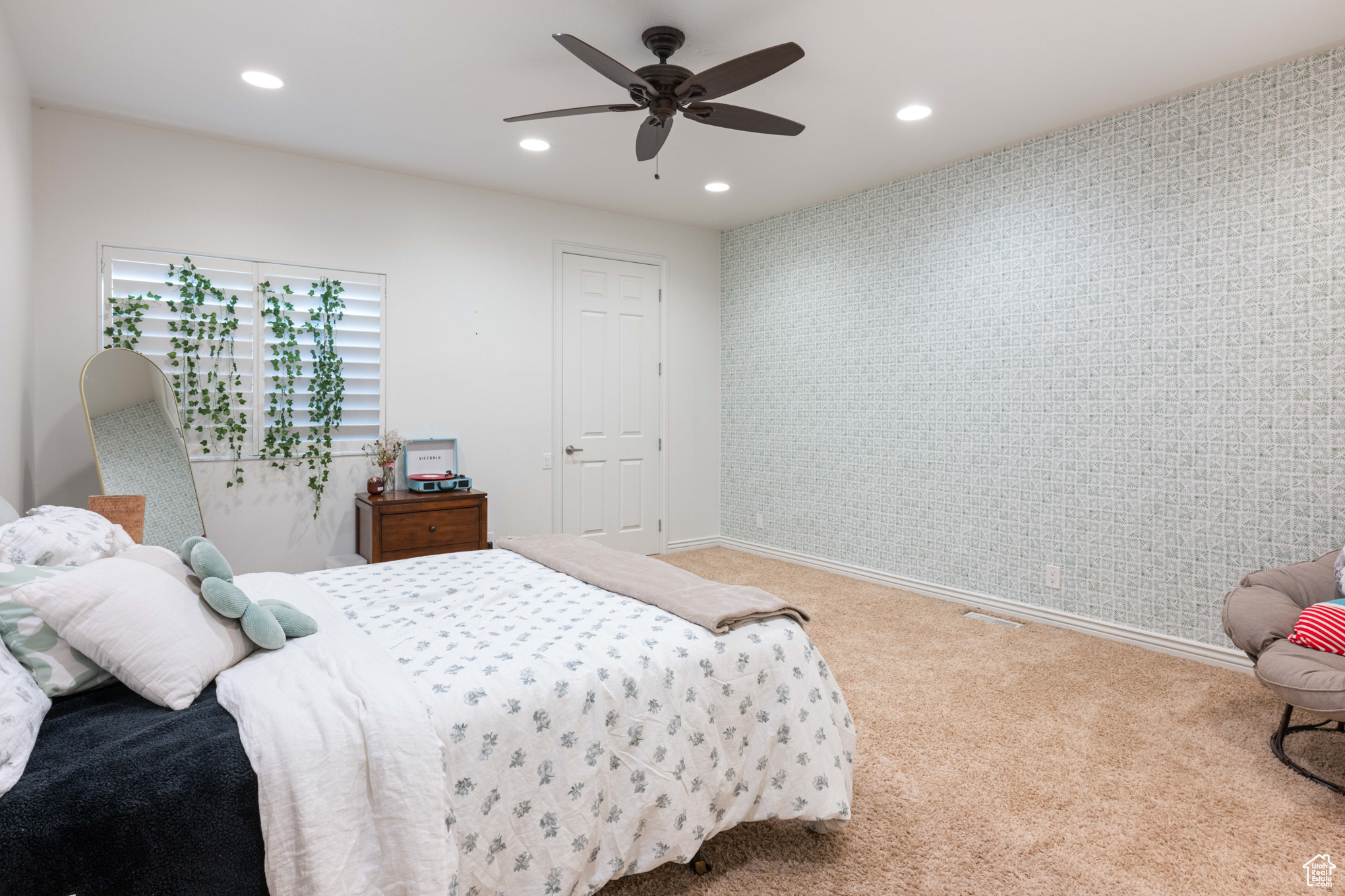 Bedroom featuring ceiling fan and carpet