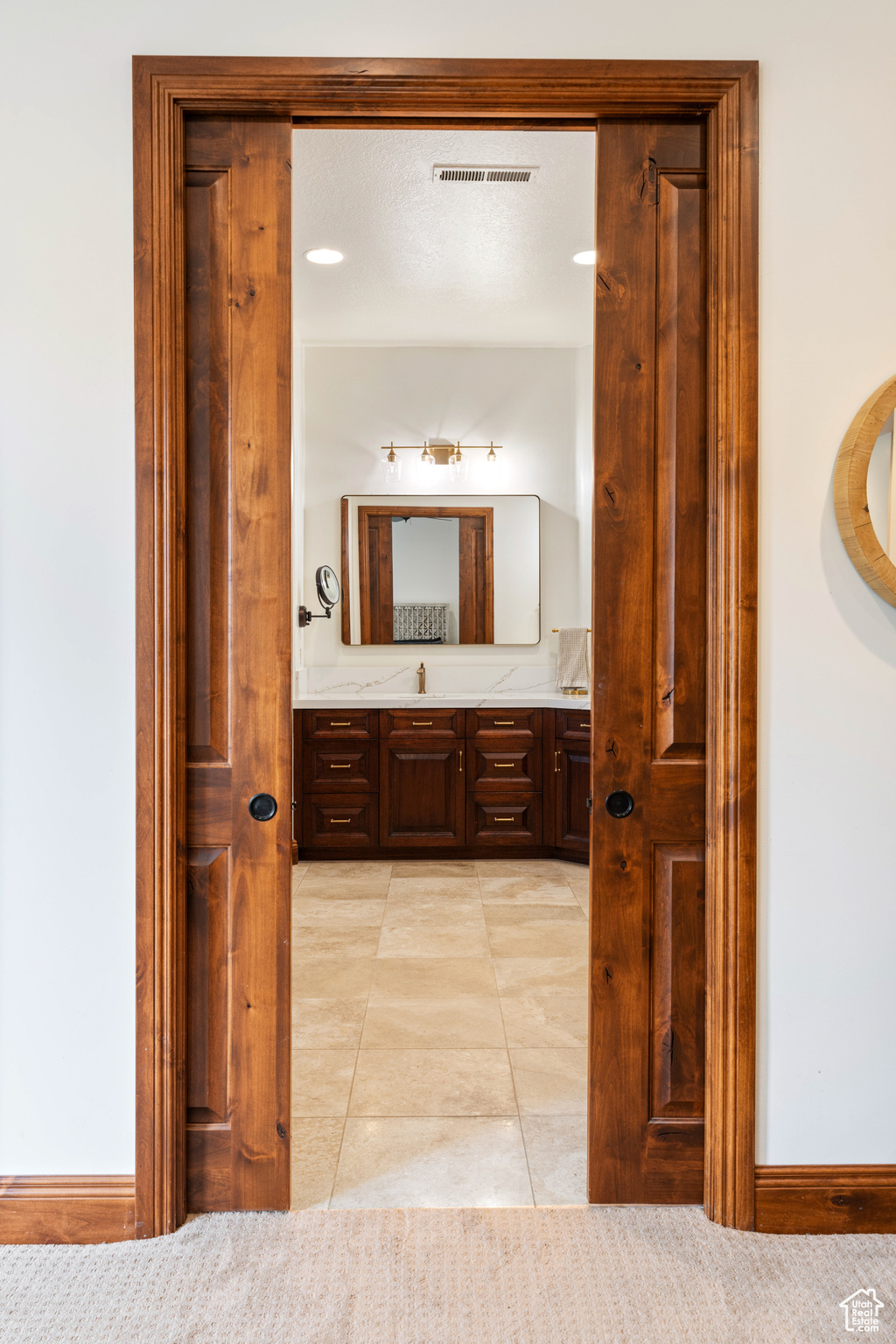 Bathroom featuring tile patterned floors and vanity