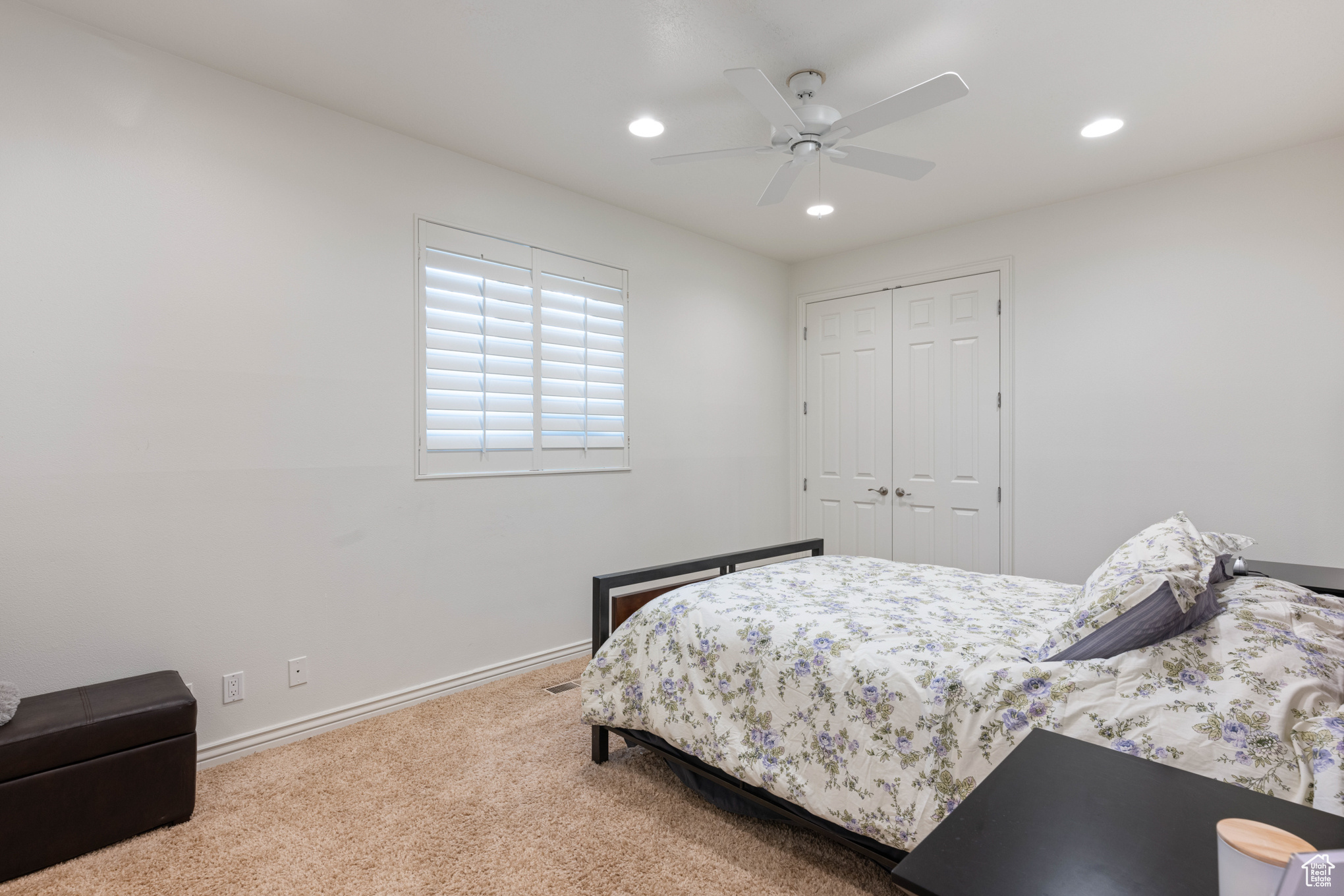 Bedroom featuring carpet flooring, ceiling fan, and a closet