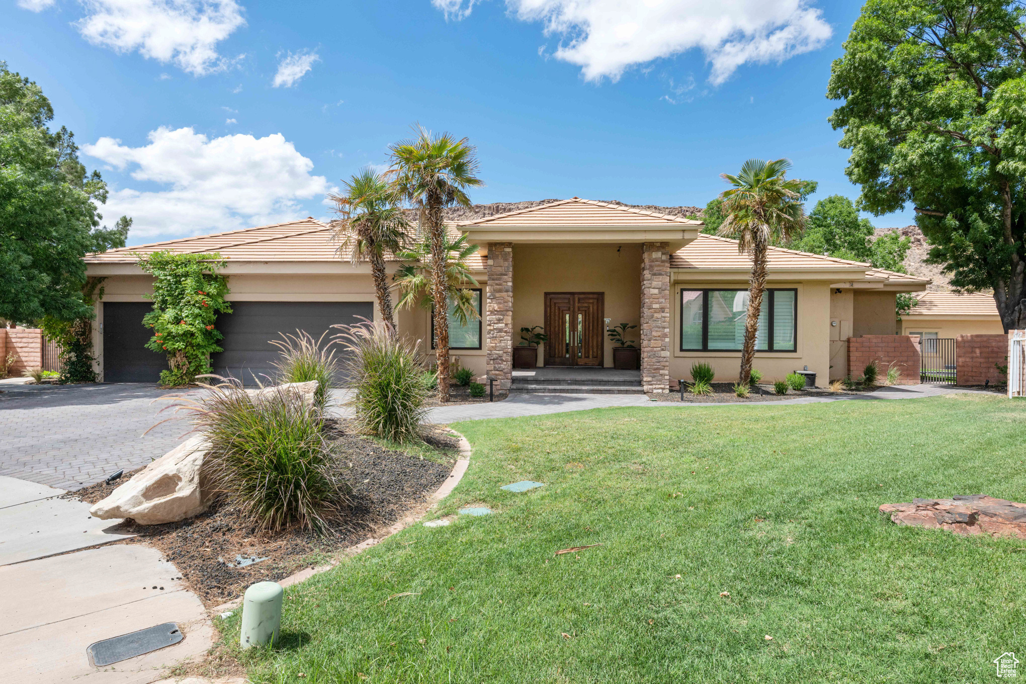 View of front of property with a front yard and a garage