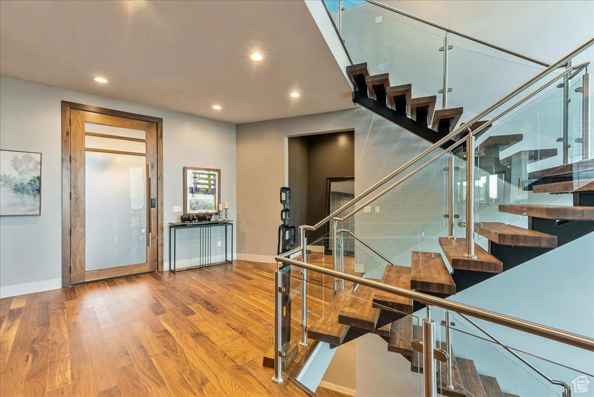 Staircase featuring hardwood / wood-style flooring