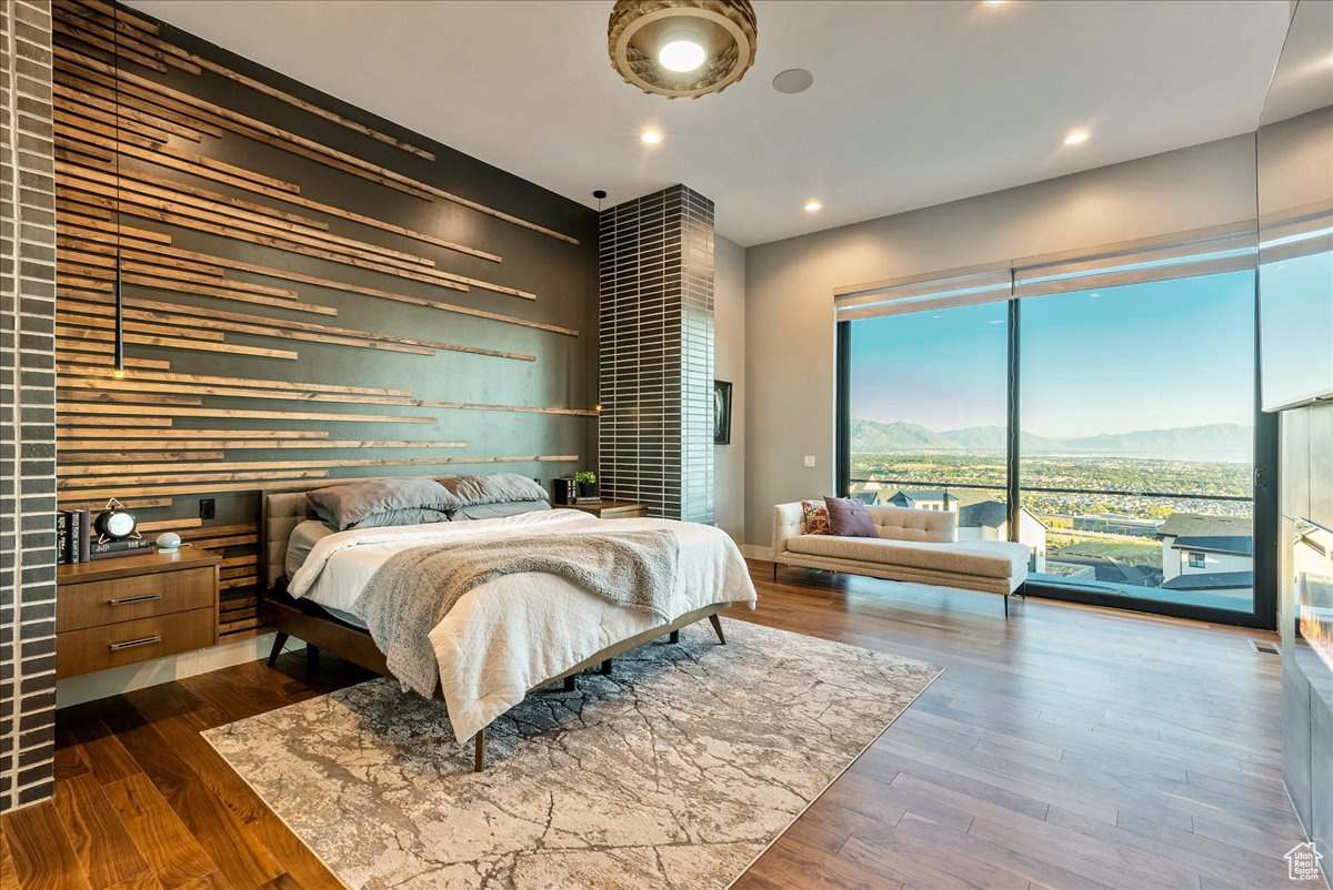 Bedroom featuring a mountain view, access to exterior, and dark wood-type flooring