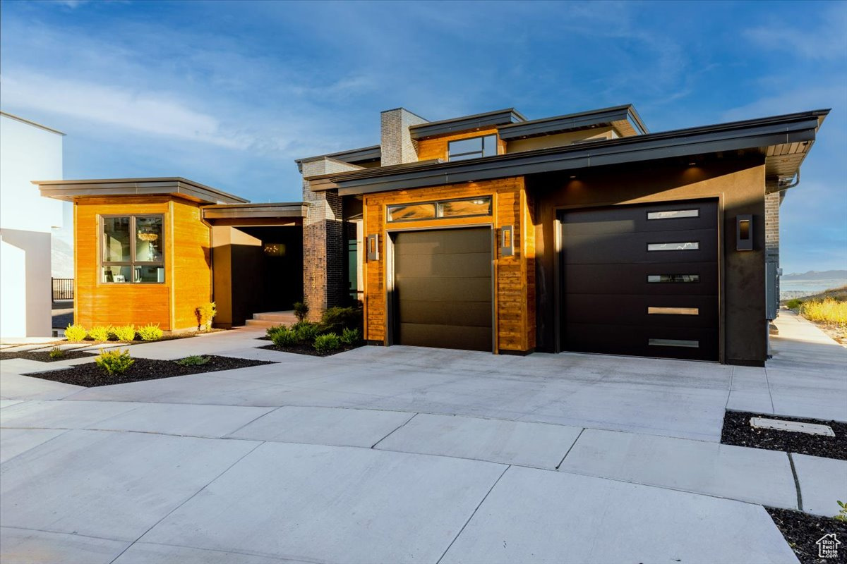 Contemporary house featuring elevator and a garage