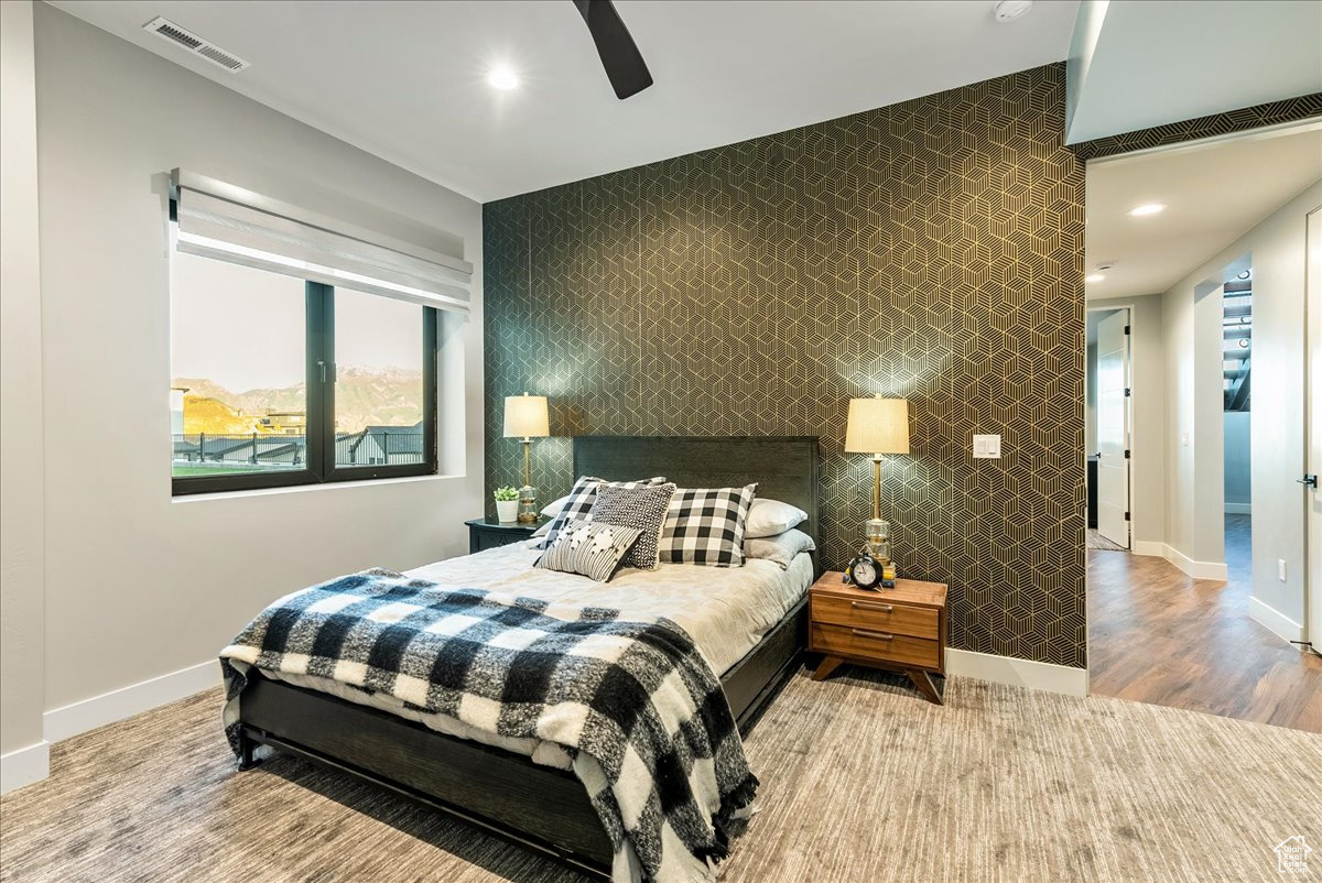 Bedroom with ceiling fan and light hardwood / wood-style floors