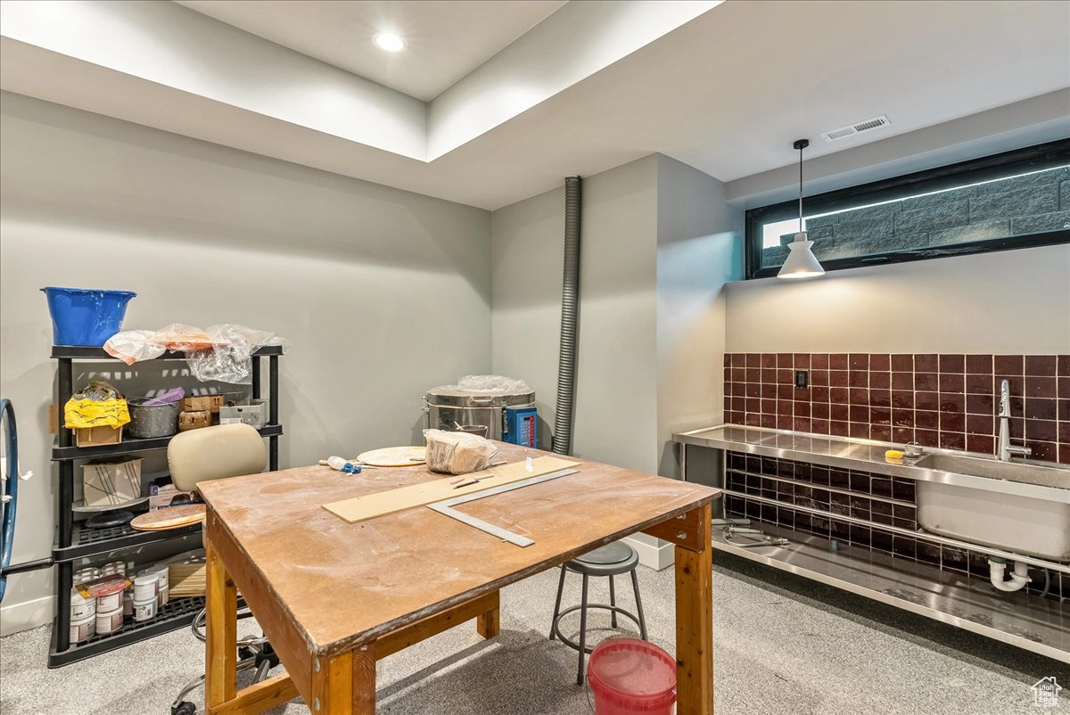 Interior space with carpet floors and hanging light fixtures