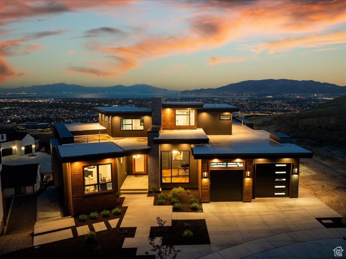 View of front of property with a mountain view and a garage