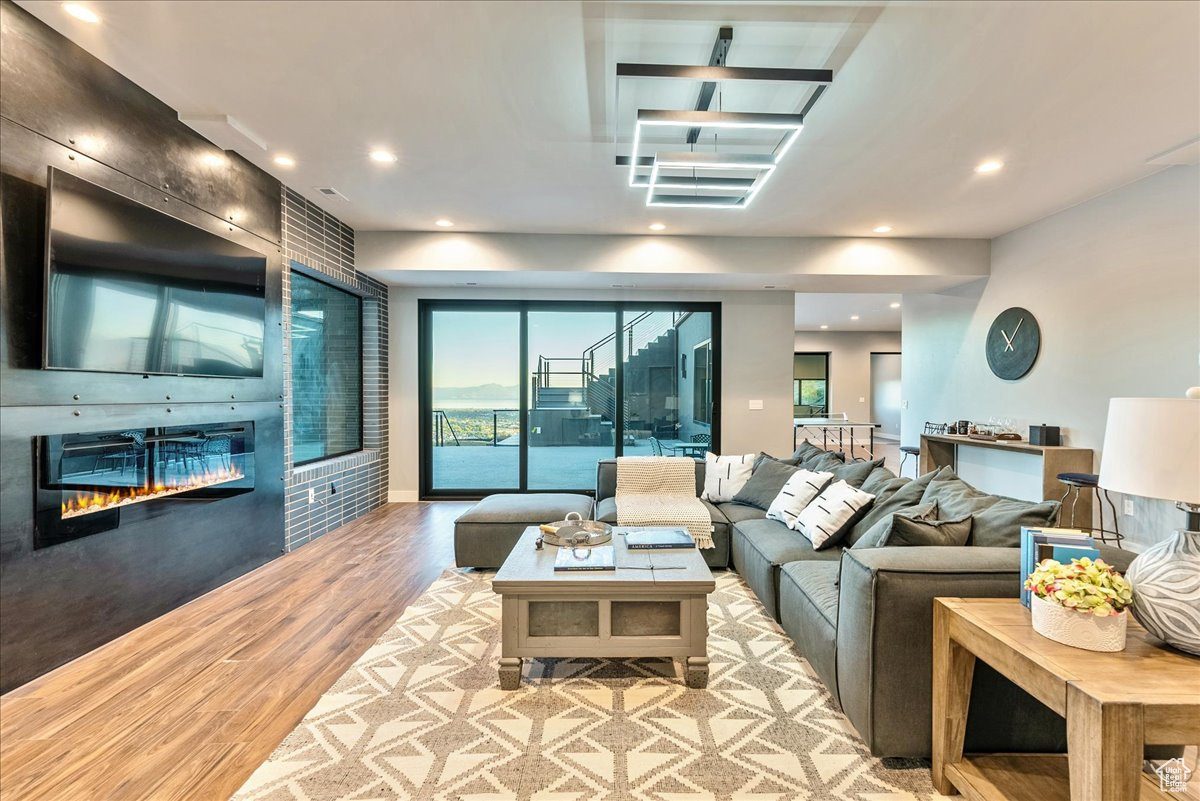 Living room with a large fireplace and light wood-type flooring