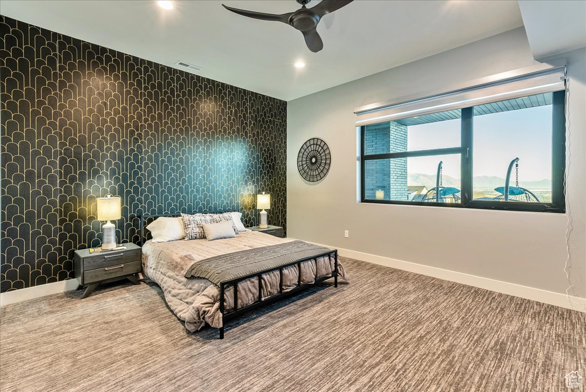 Bedroom featuring carpet and ceiling fan