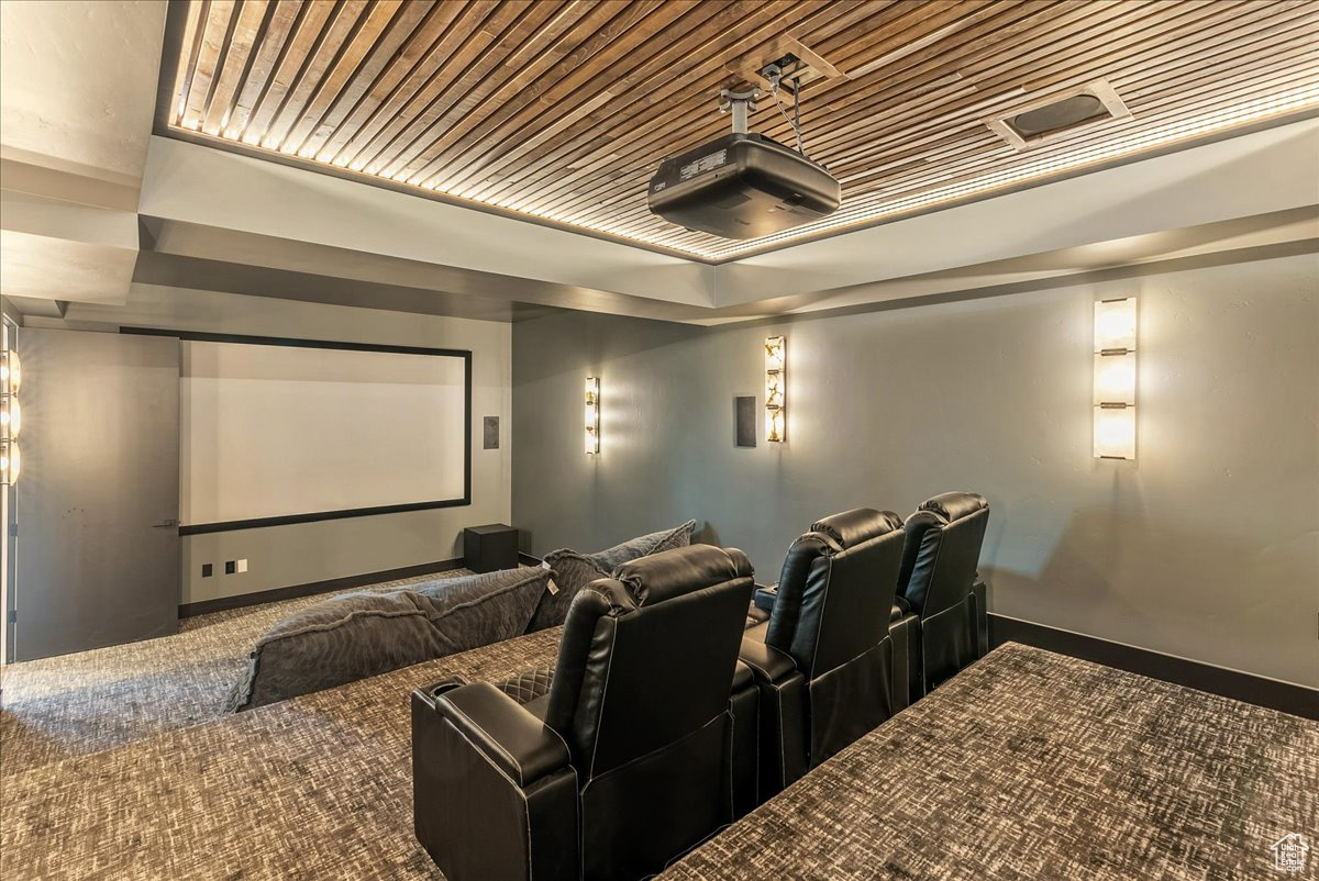 Home theater with wooden ceiling and carpet floors