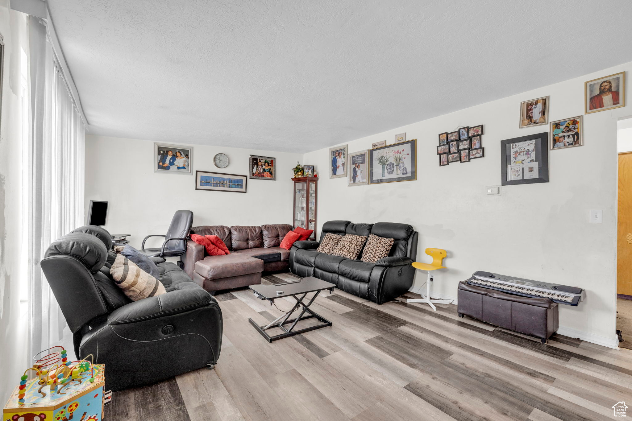 Living room featuring light hardwood / wood-style floors and a textured ceiling