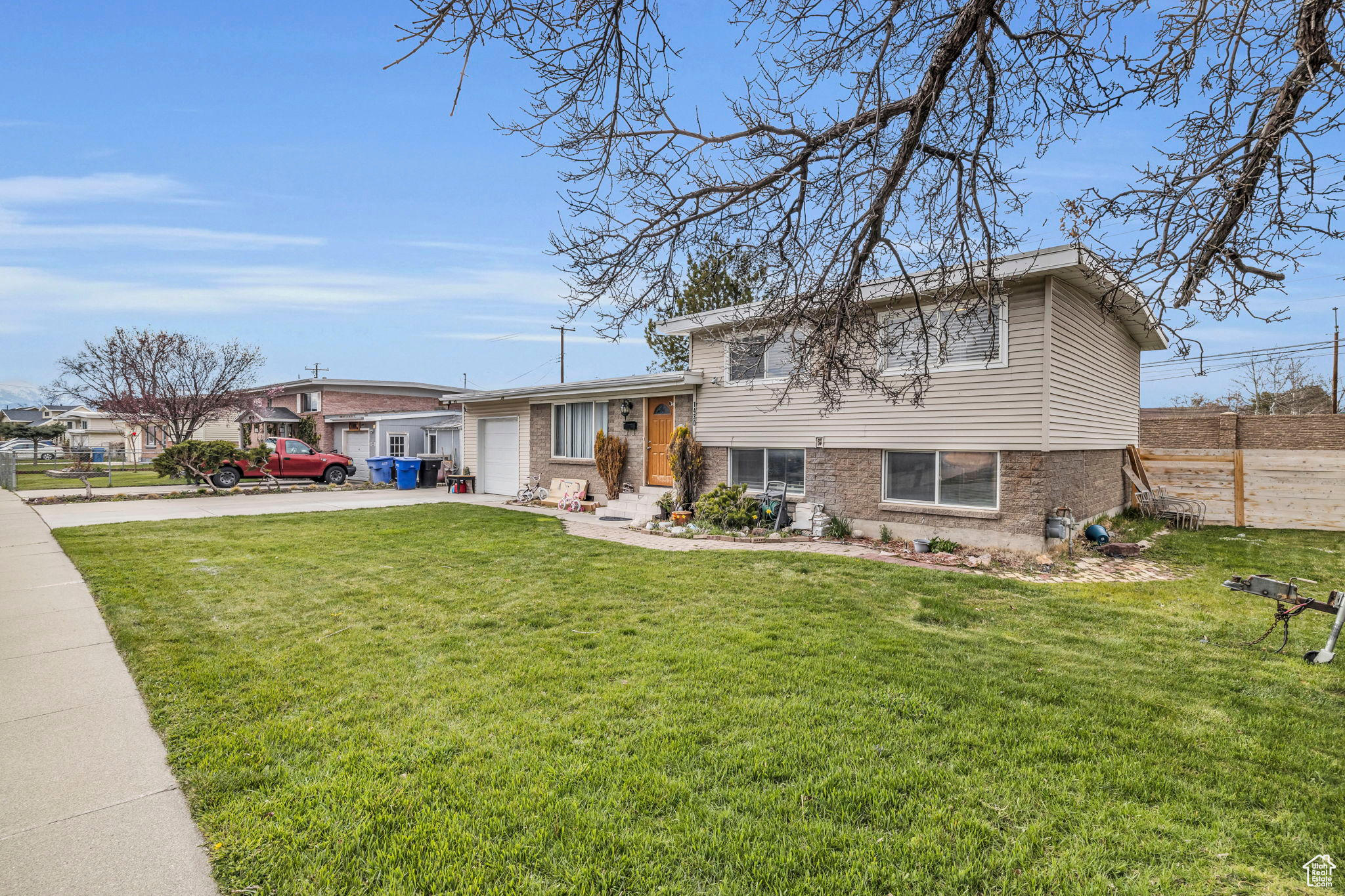 Split level home with a front yard and a garage