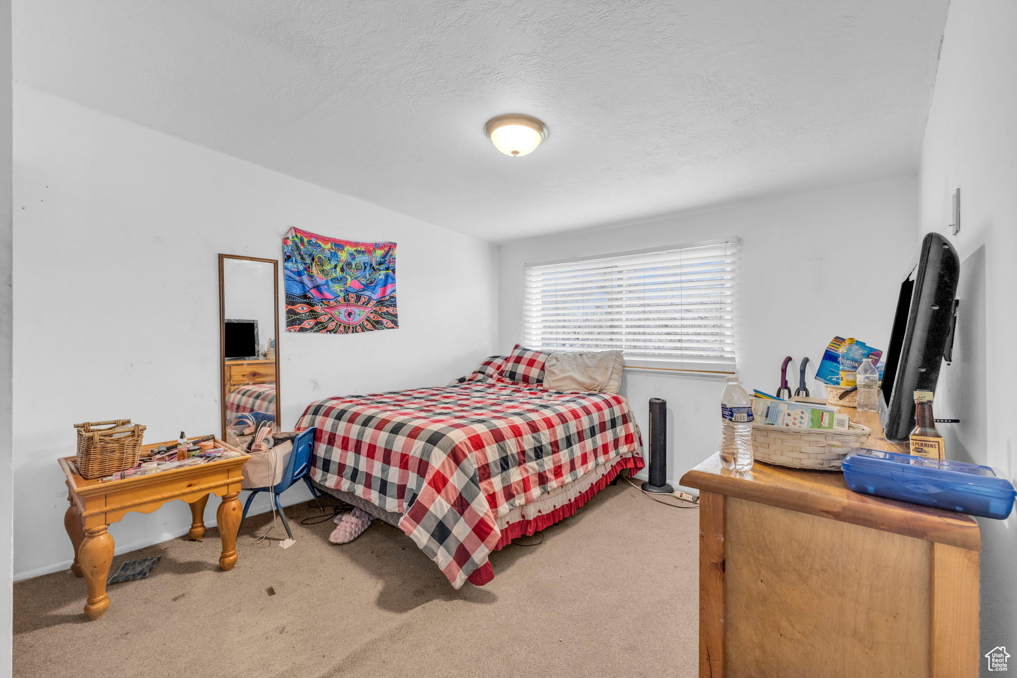 Bedroom with carpet and a textured ceiling