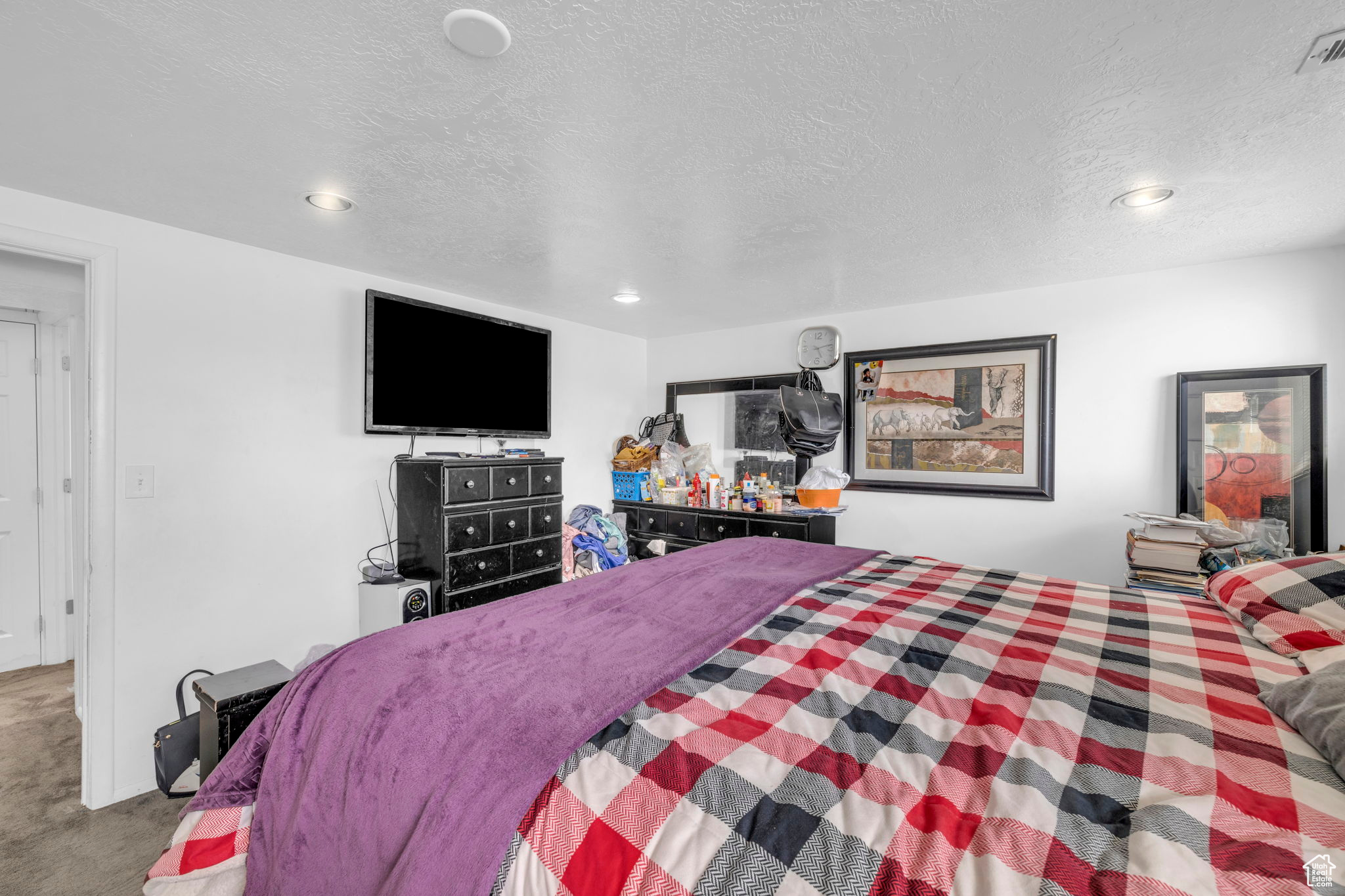 Carpeted bedroom with a textured ceiling