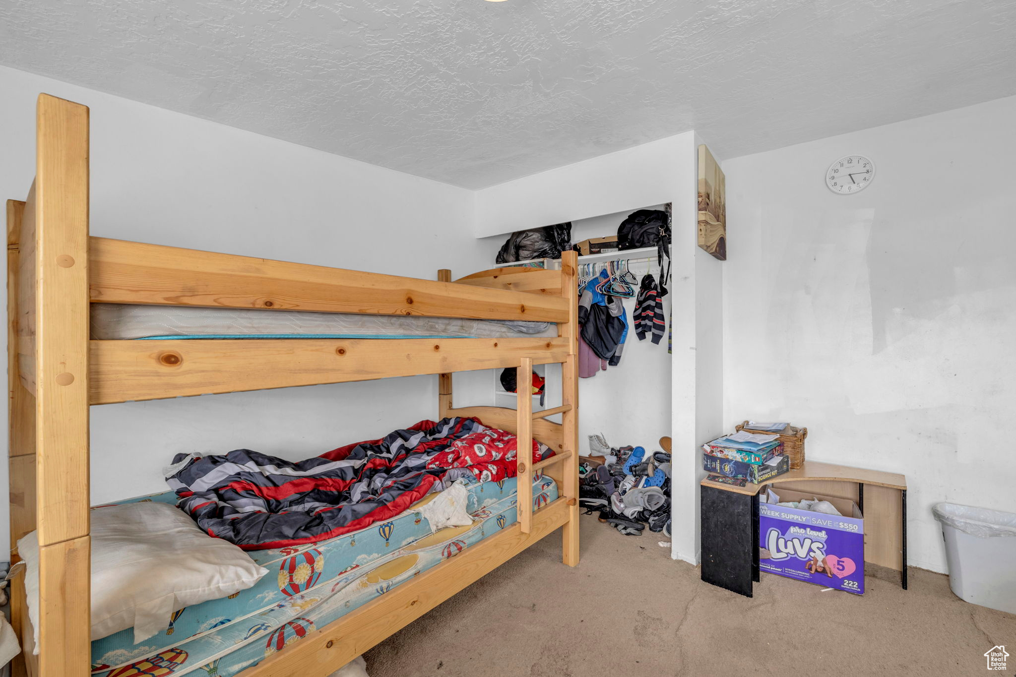 Bedroom featuring a textured ceiling and a closet