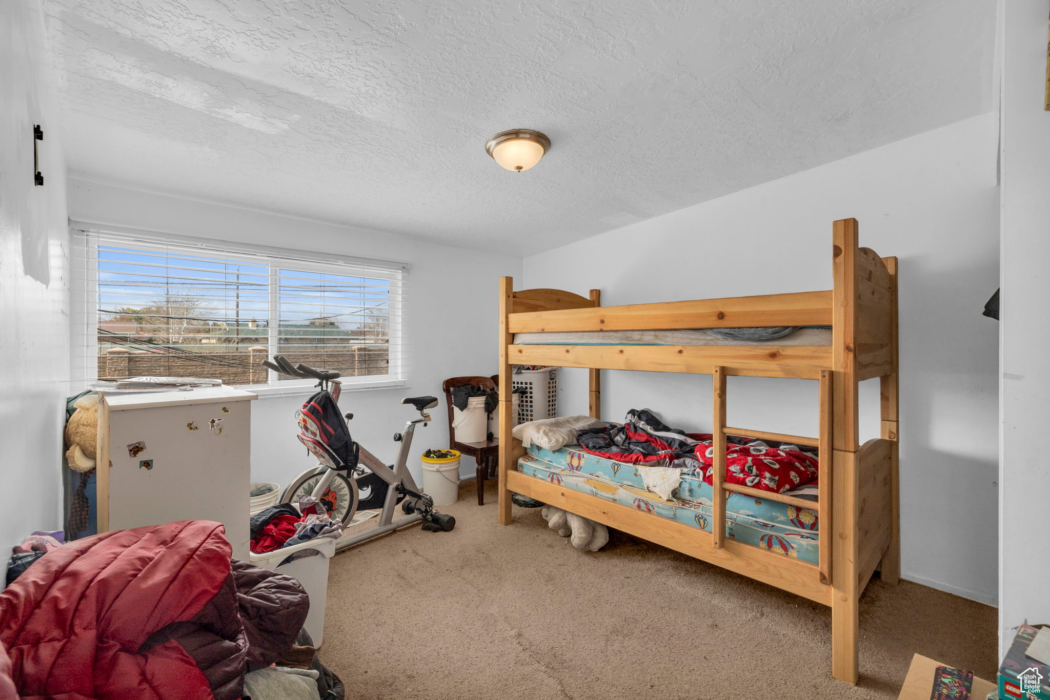 Carpeted bedroom featuring a textured ceiling