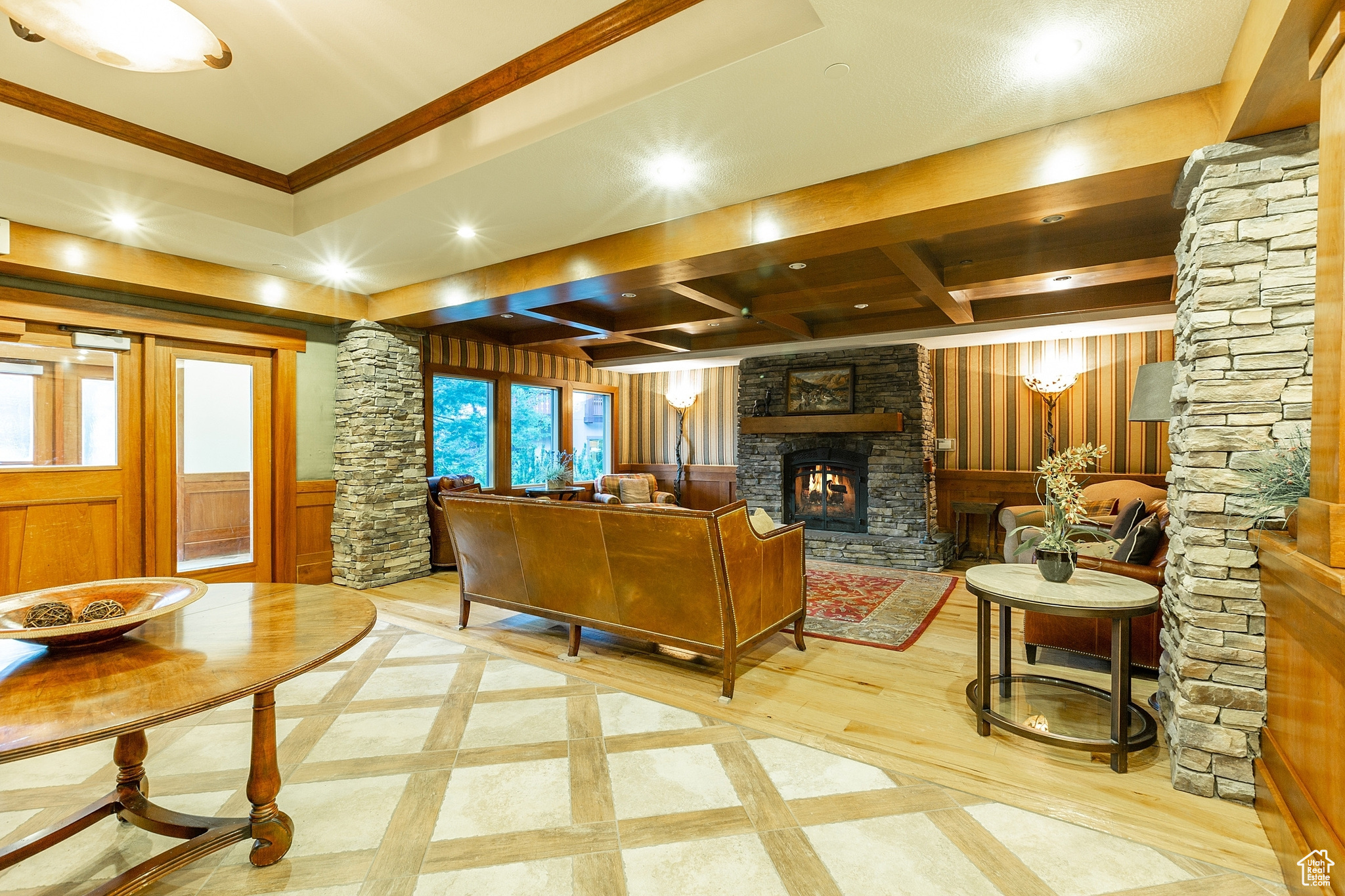 Interior space with decorative columns, a fireplace, and ornamental molding