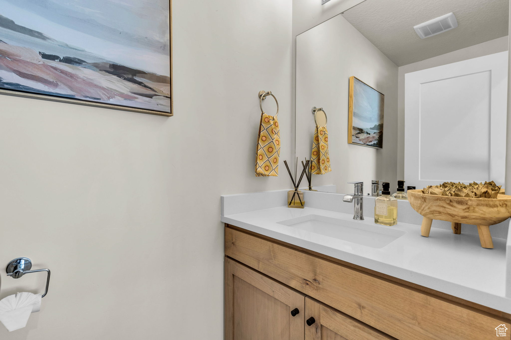 Bathroom featuring a textured ceiling and vanity