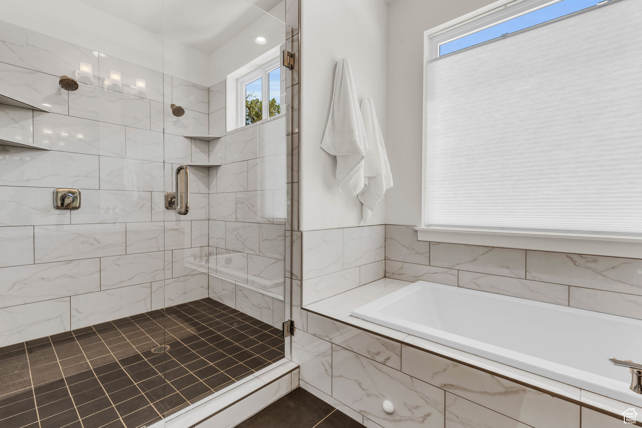 Bathroom with tile patterned flooring and plus walk in shower