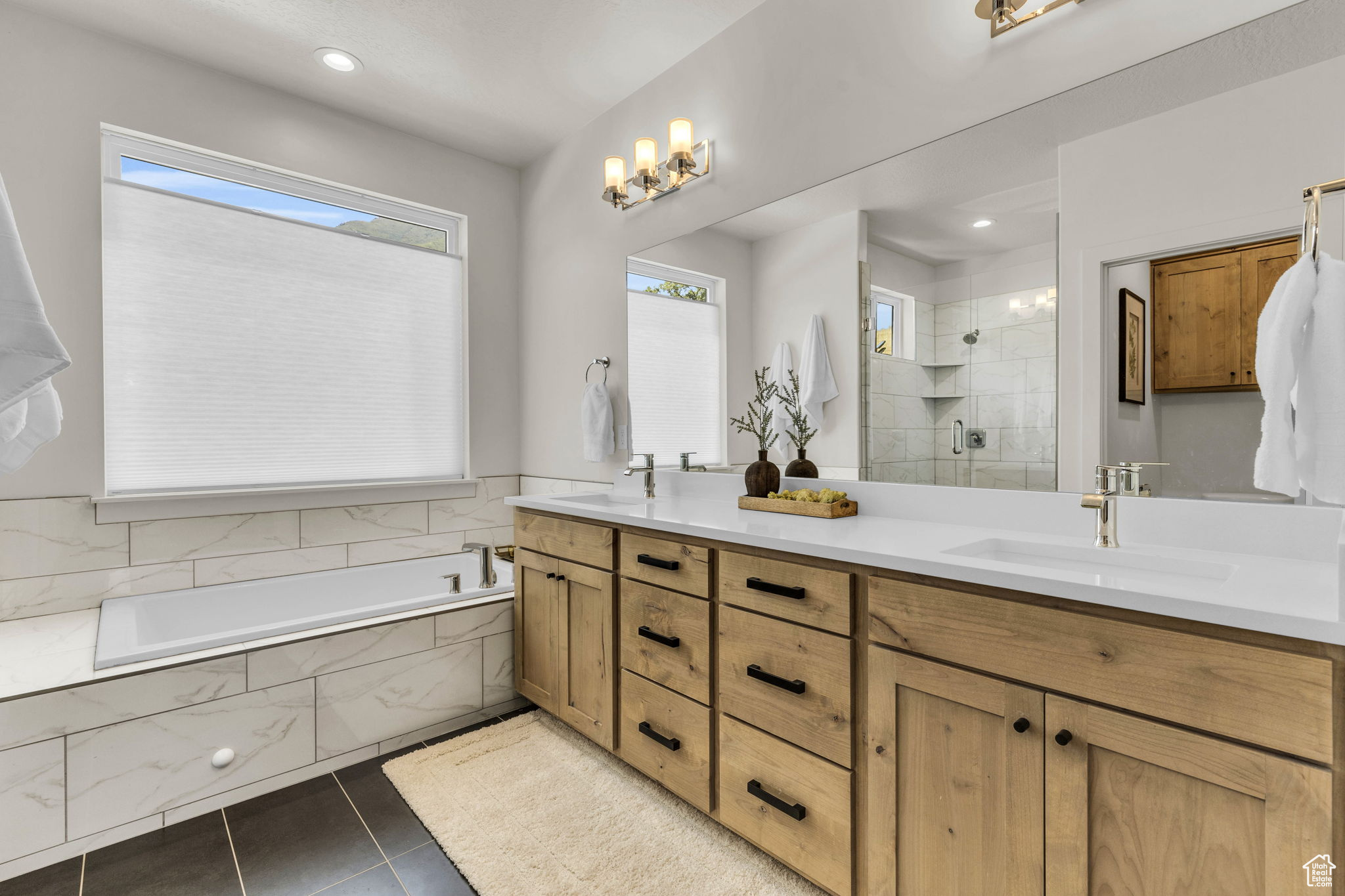 Bathroom with shower with separate bathtub, vanity, and tile patterned floors