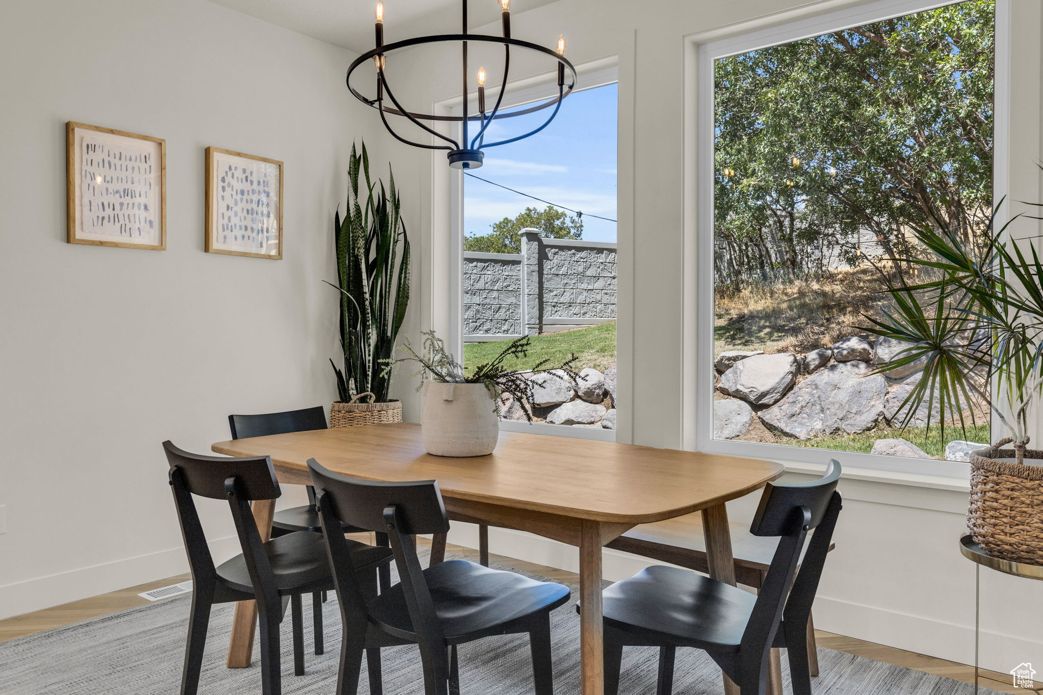 Dining area with light hardwood / wood-style flooring and a notable chandelier