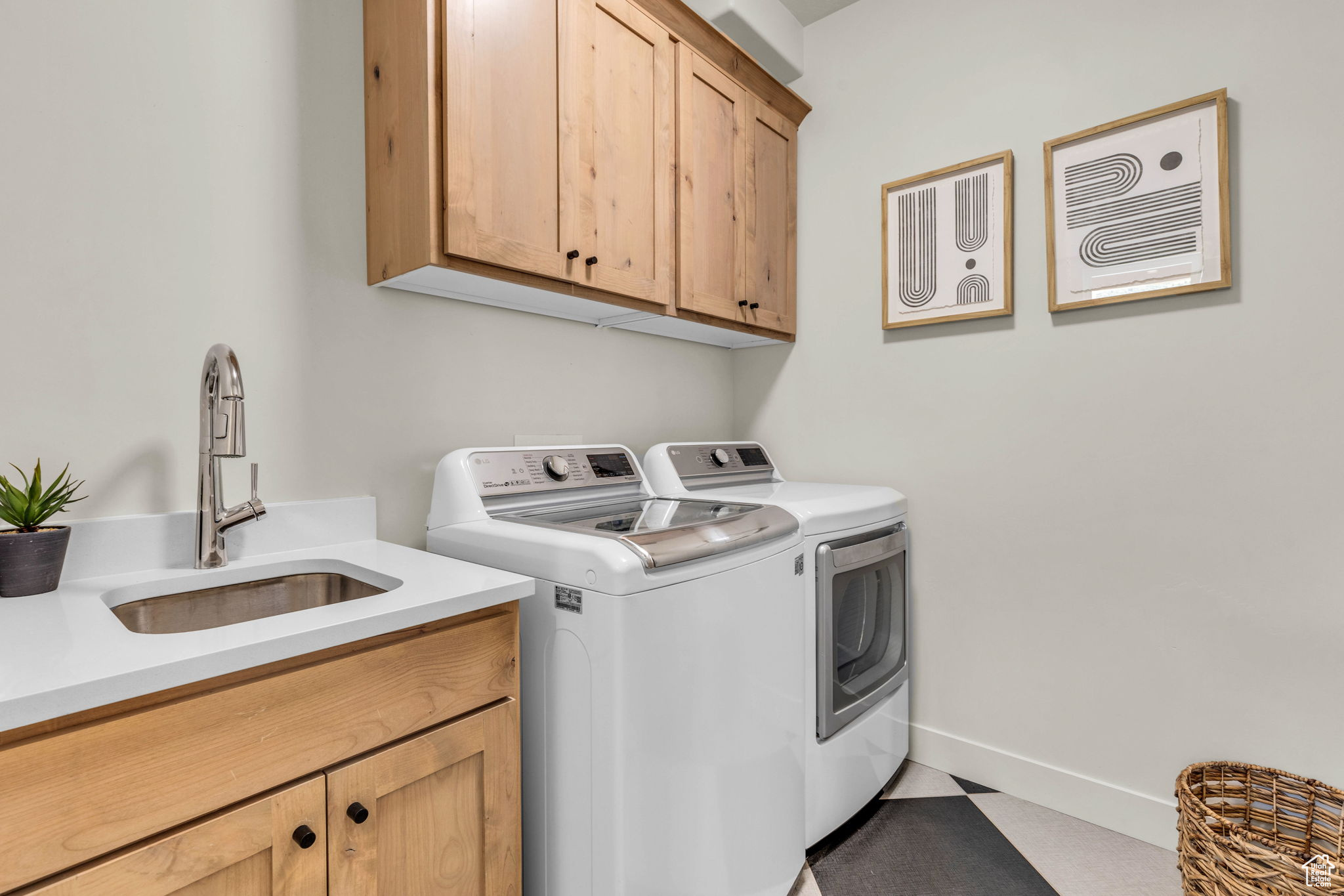 Washroom featuring sink, cabinets, and independent washer and dryer