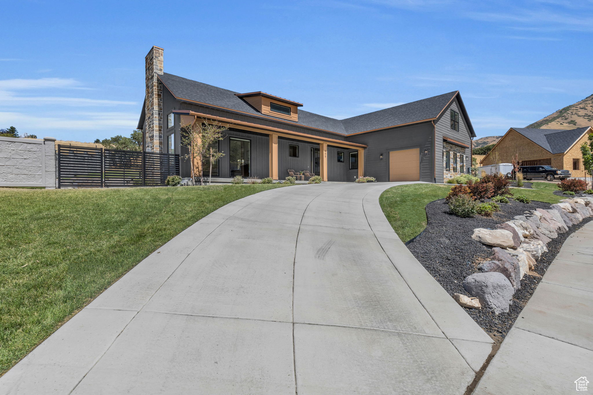 View of front of house featuring a garage and a front yard