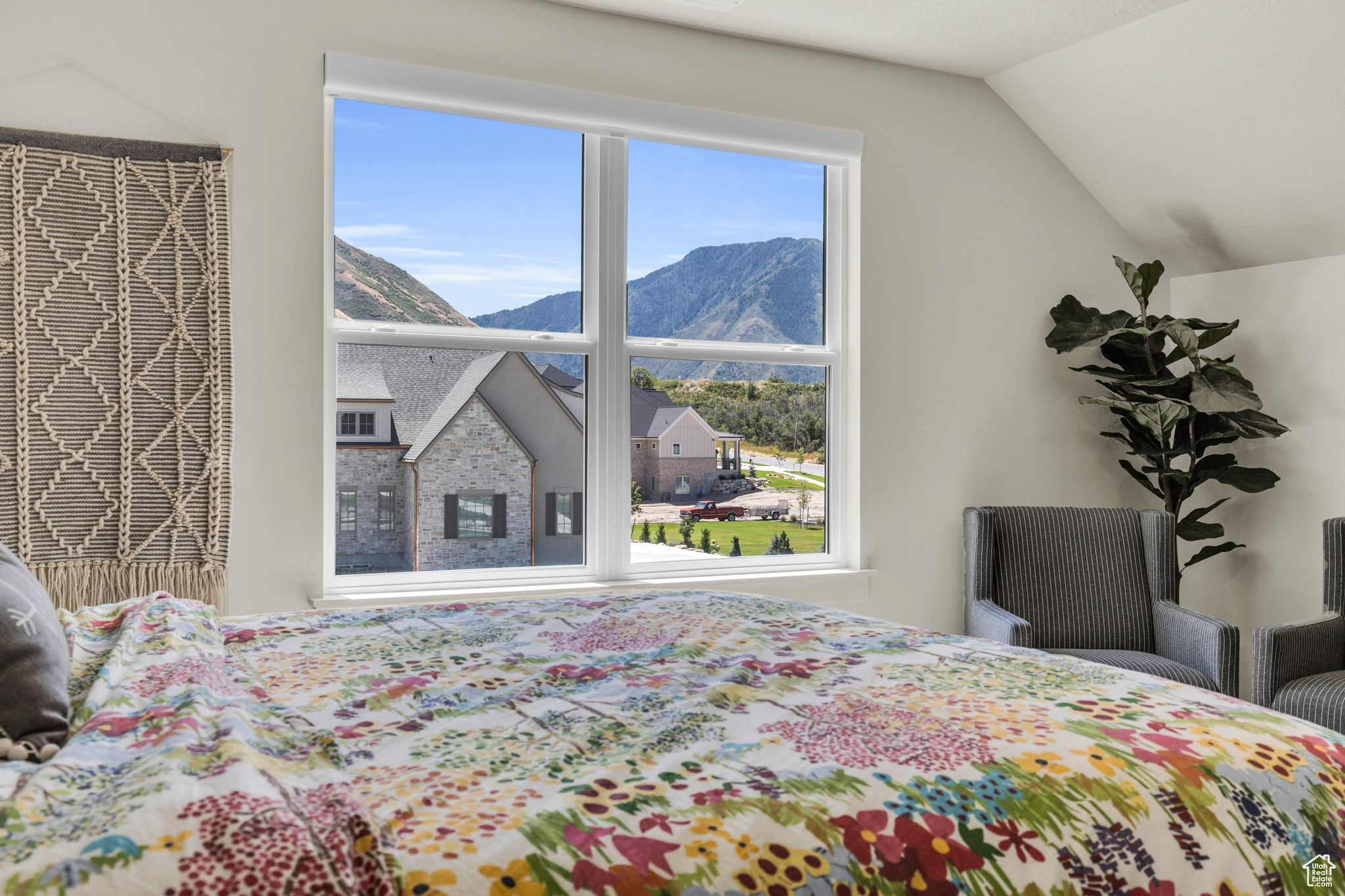 Bedroom with a mountain view and vaulted ceiling