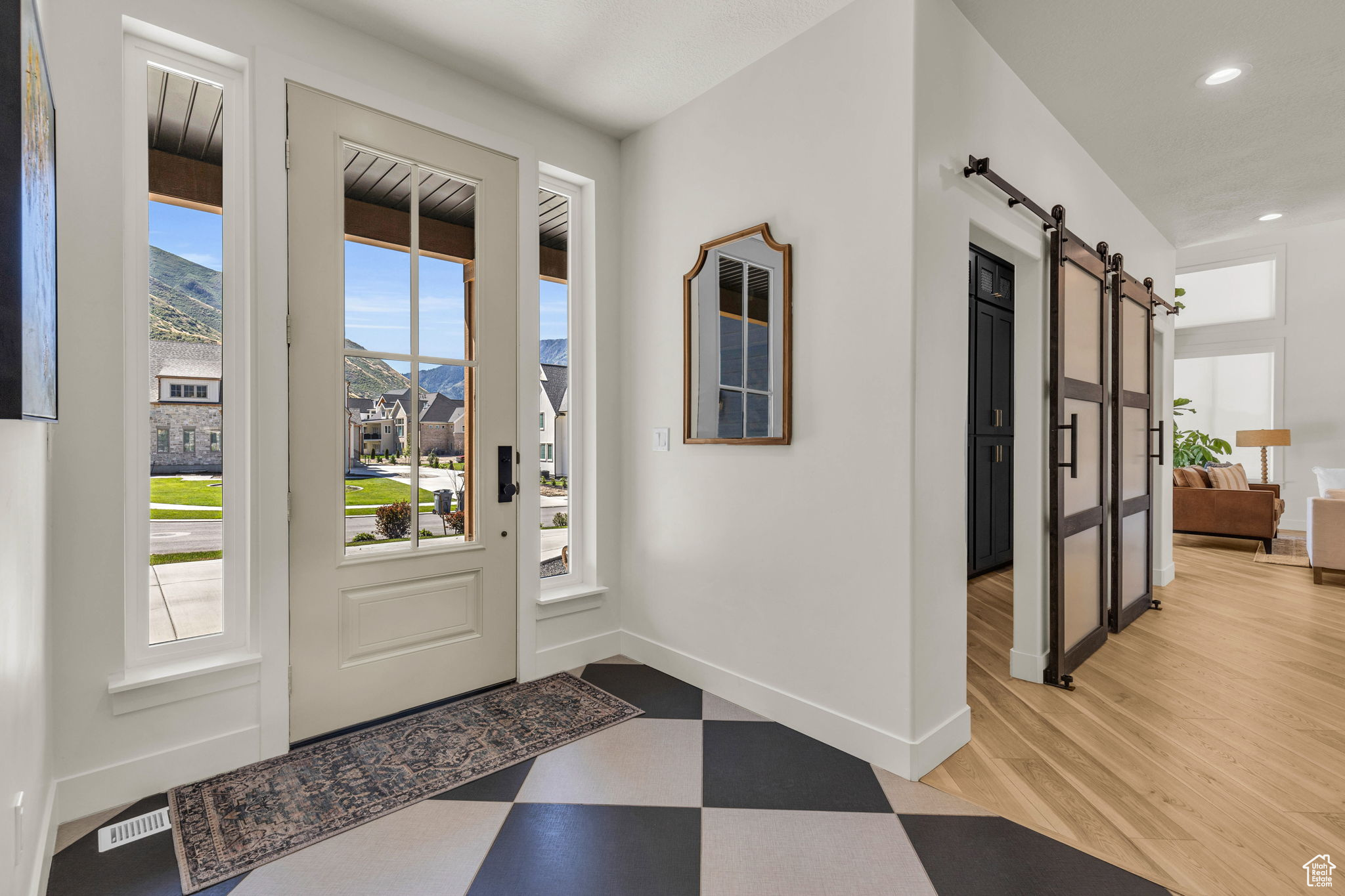 Foyer featuring a mountain view, a barn door, and light hardwood / wood-style flooring