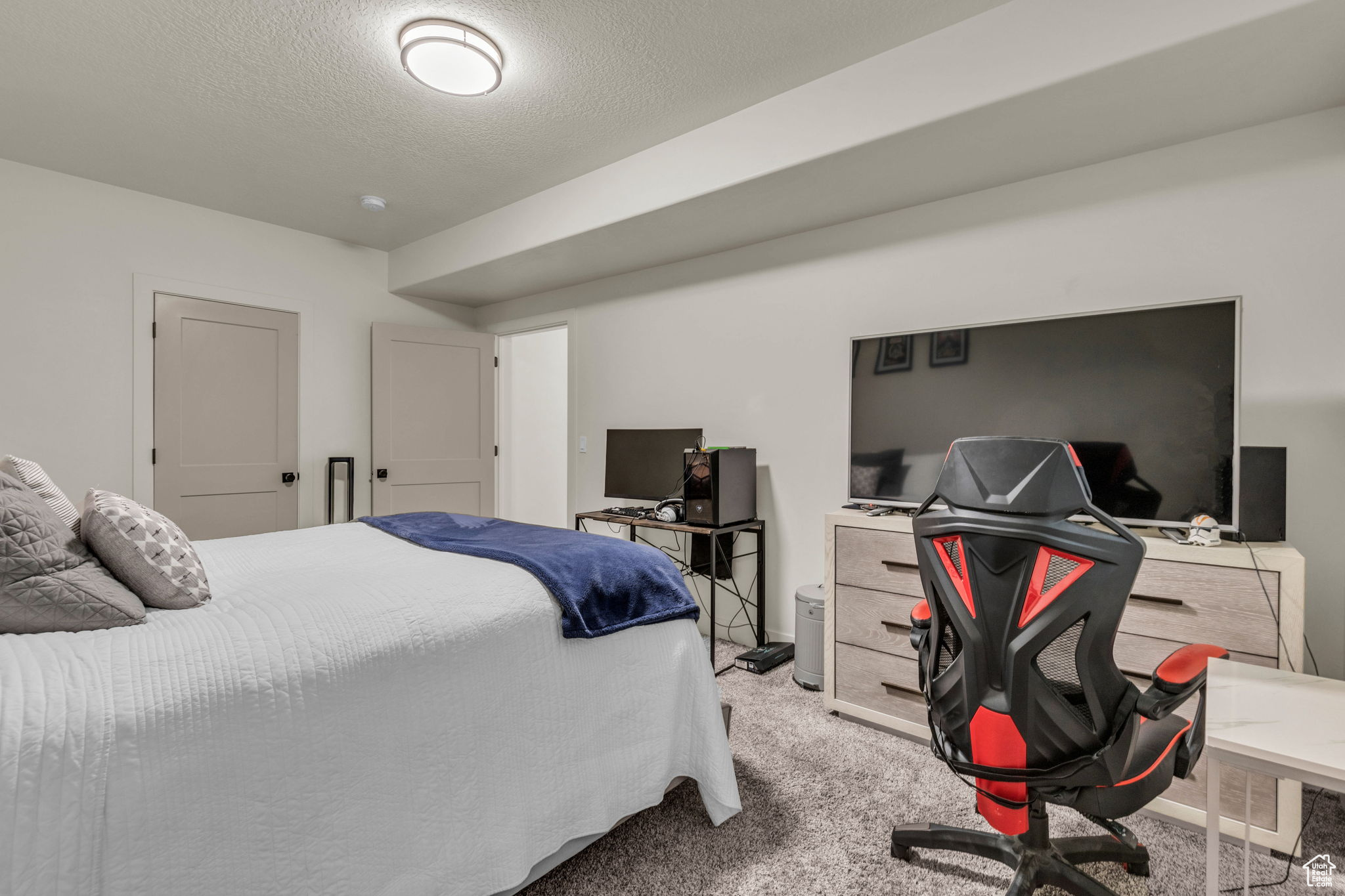 Bedroom with carpet and a textured ceiling