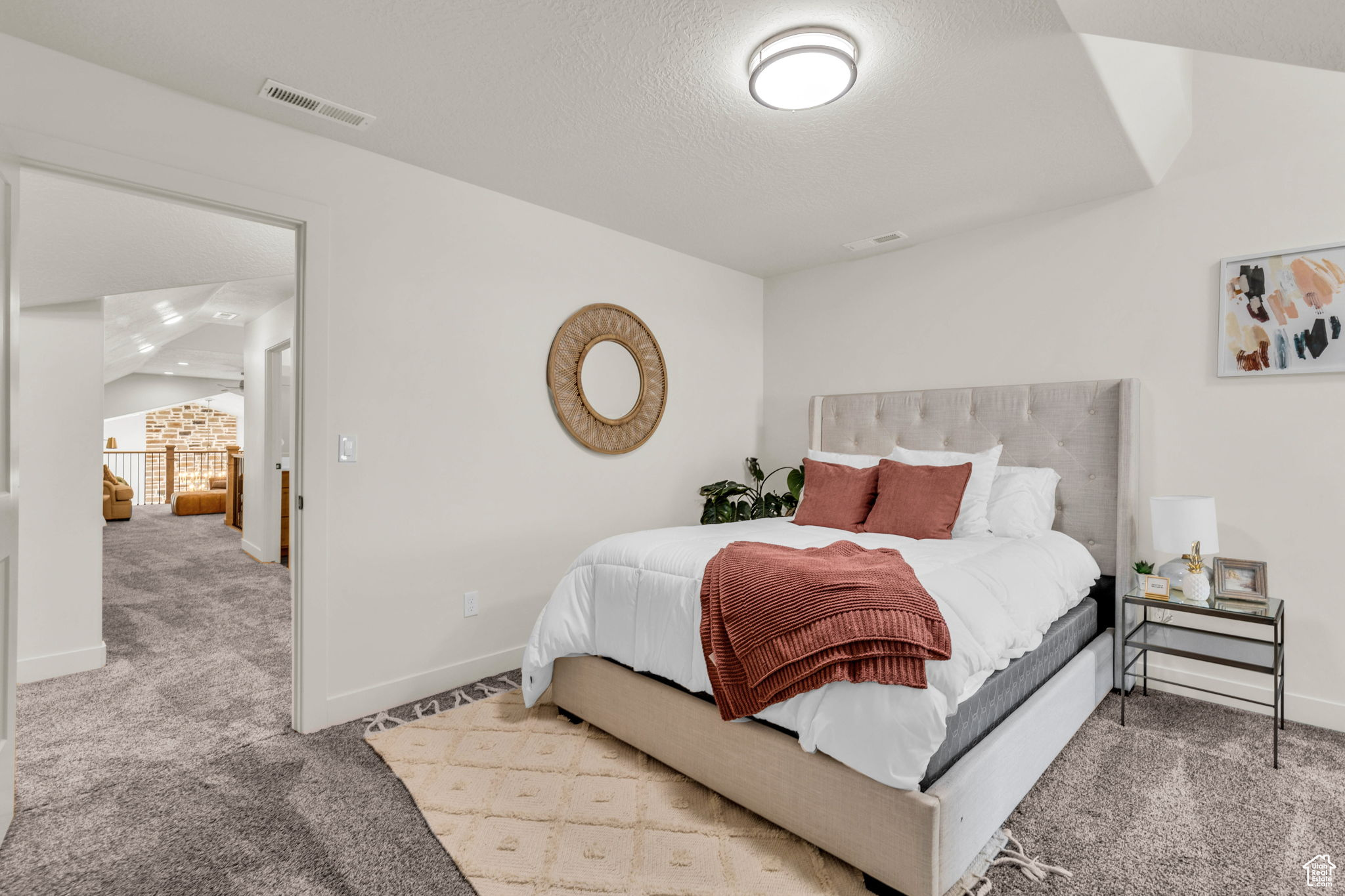 Carpeted bedroom with a textured ceiling