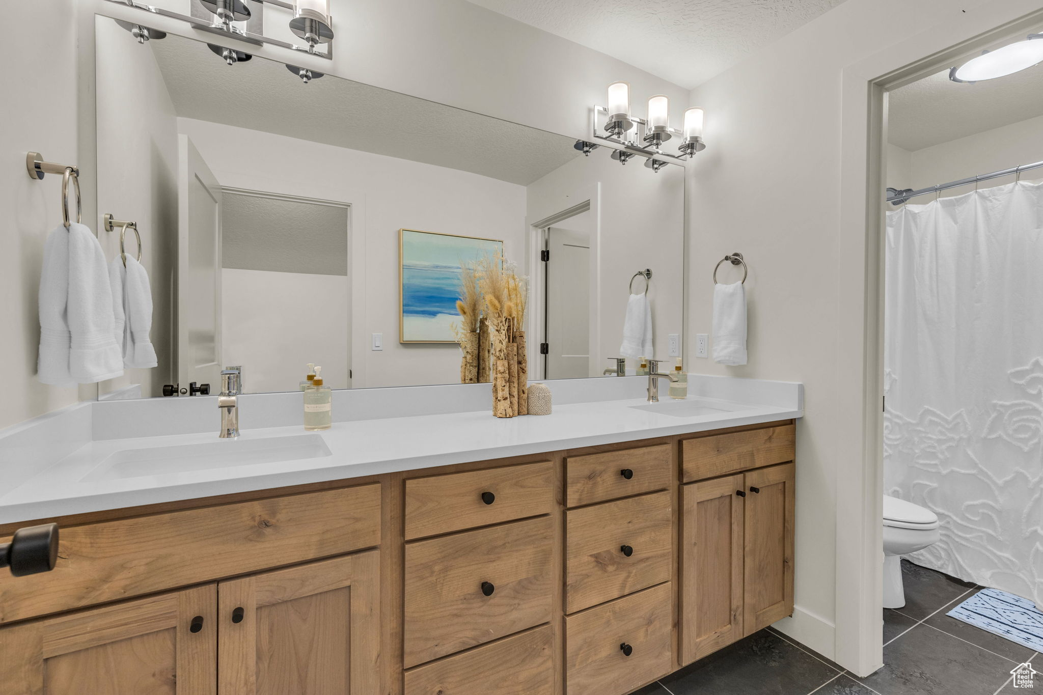 Bathroom featuring tile patterned flooring, vanity, and toilet