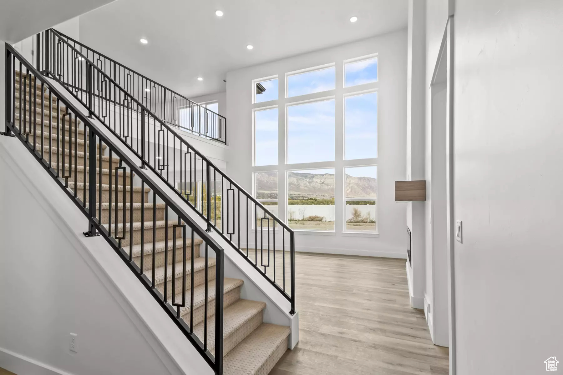 Stairs with a mountain view and hardwood / wood-style flooring