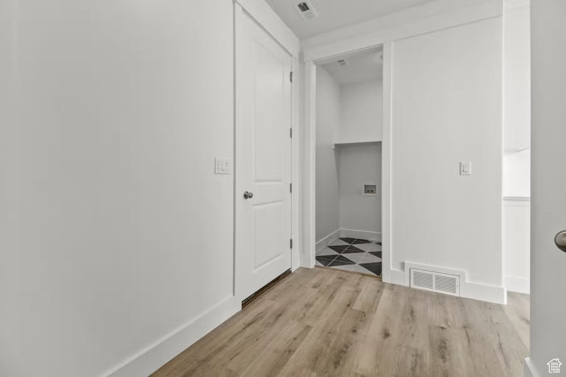 Hall with light hardwood / wood-style flooring