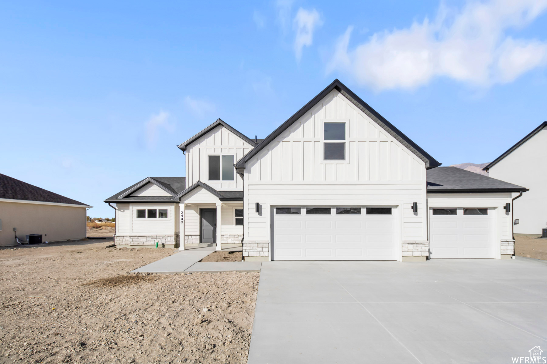 Modern farmhouse style home featuring a garage and central air condition unit