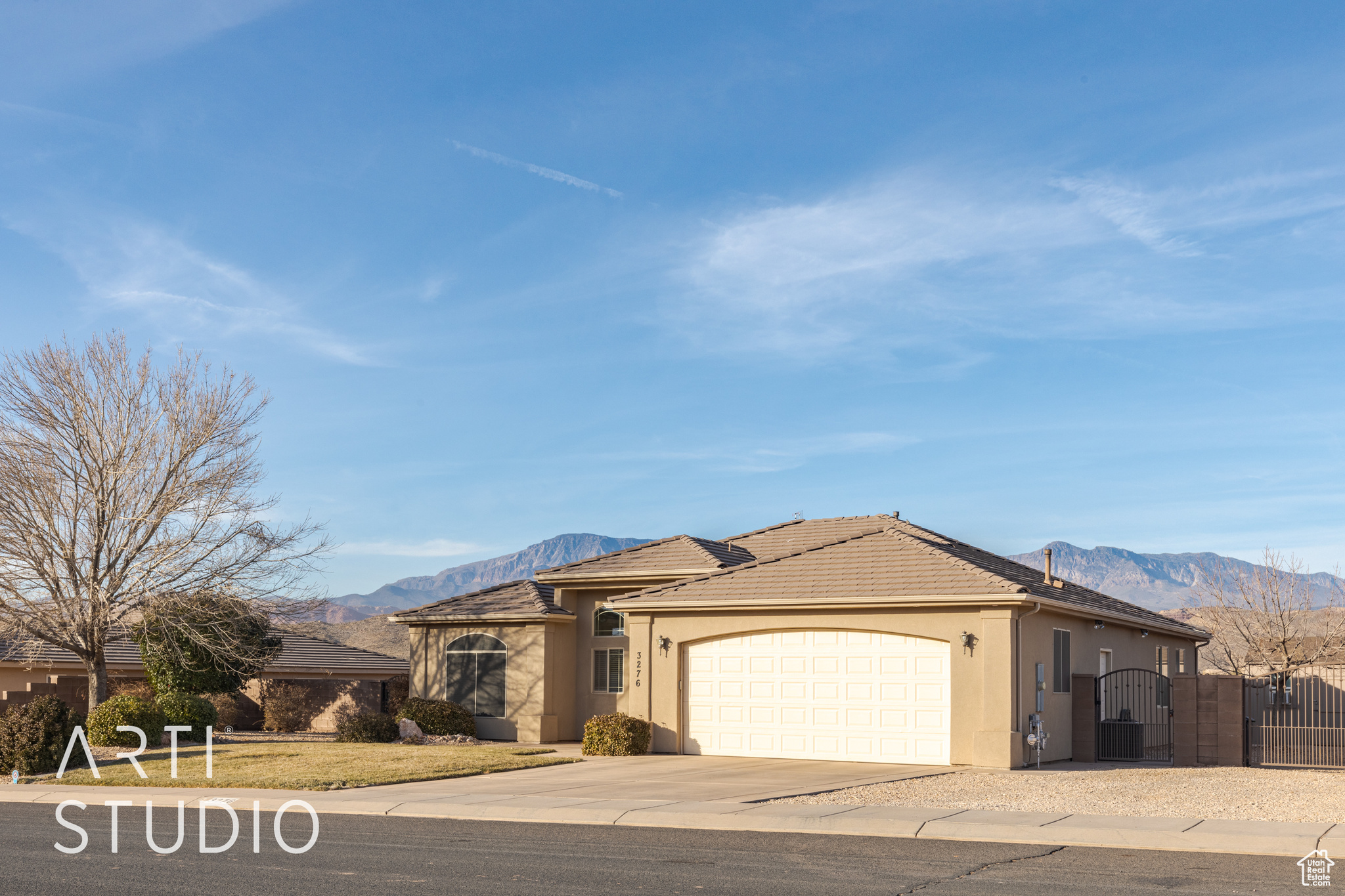 View of front of home with a mountain view and a garage