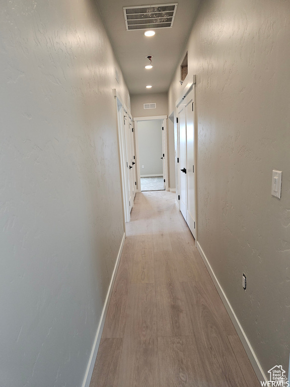 Corridor with light wood-type flooring