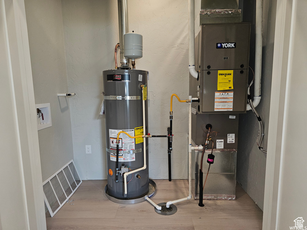 Utilities with heating unit and strapped water heater