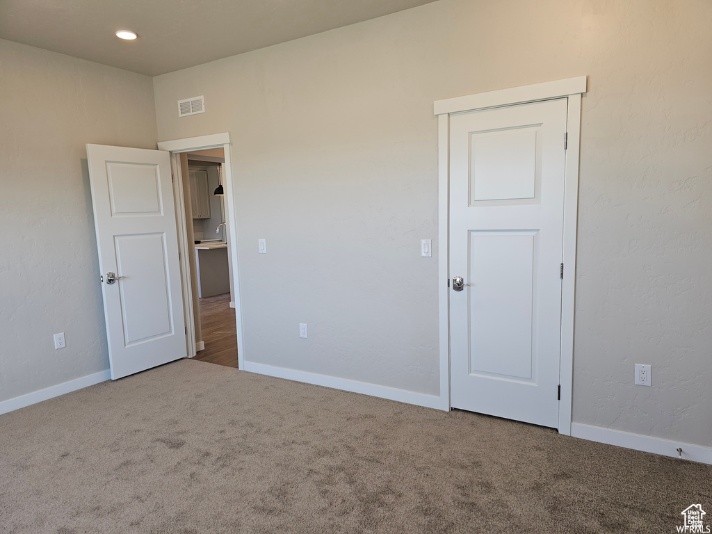 Unfurnished bedroom with carpet floors